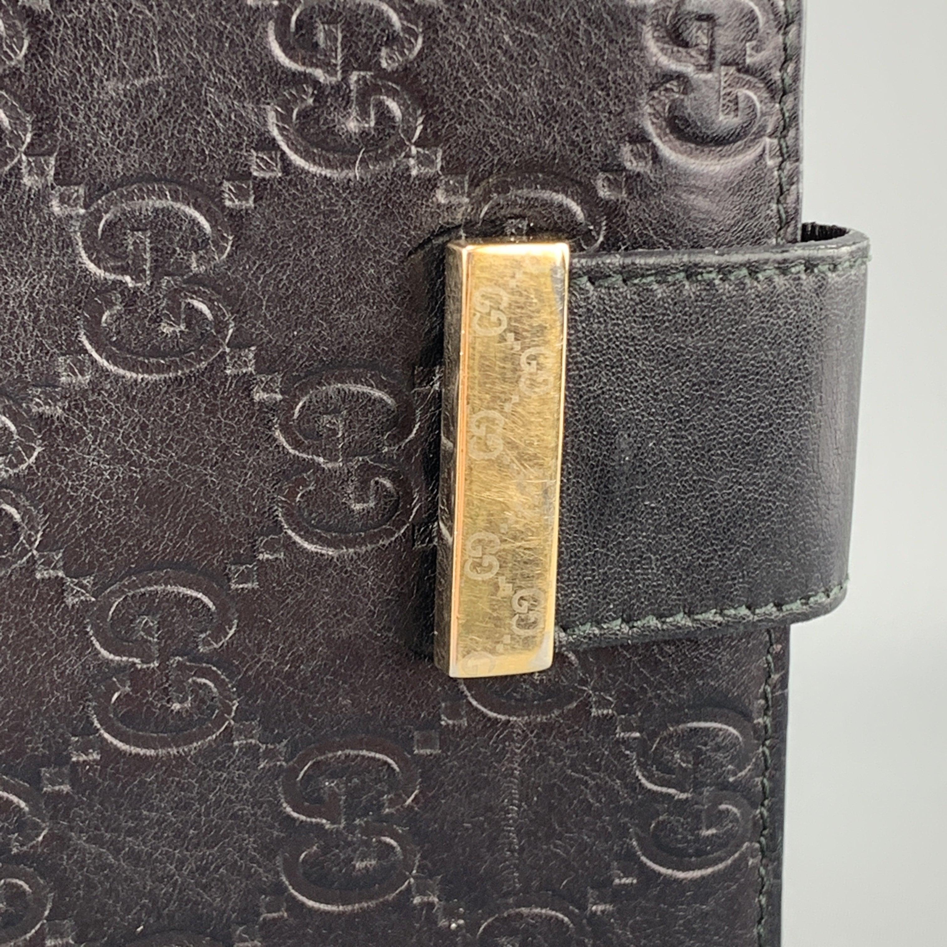 Archive GUCCI checkbook wallet comes in black Guccissima monogram embossed leather with a flap pocket back, flap front with gold tone accented tab snap closure, and internal storage. Snap is loose. As-is. Made in Italy.Good
Pre-Owned Condition.