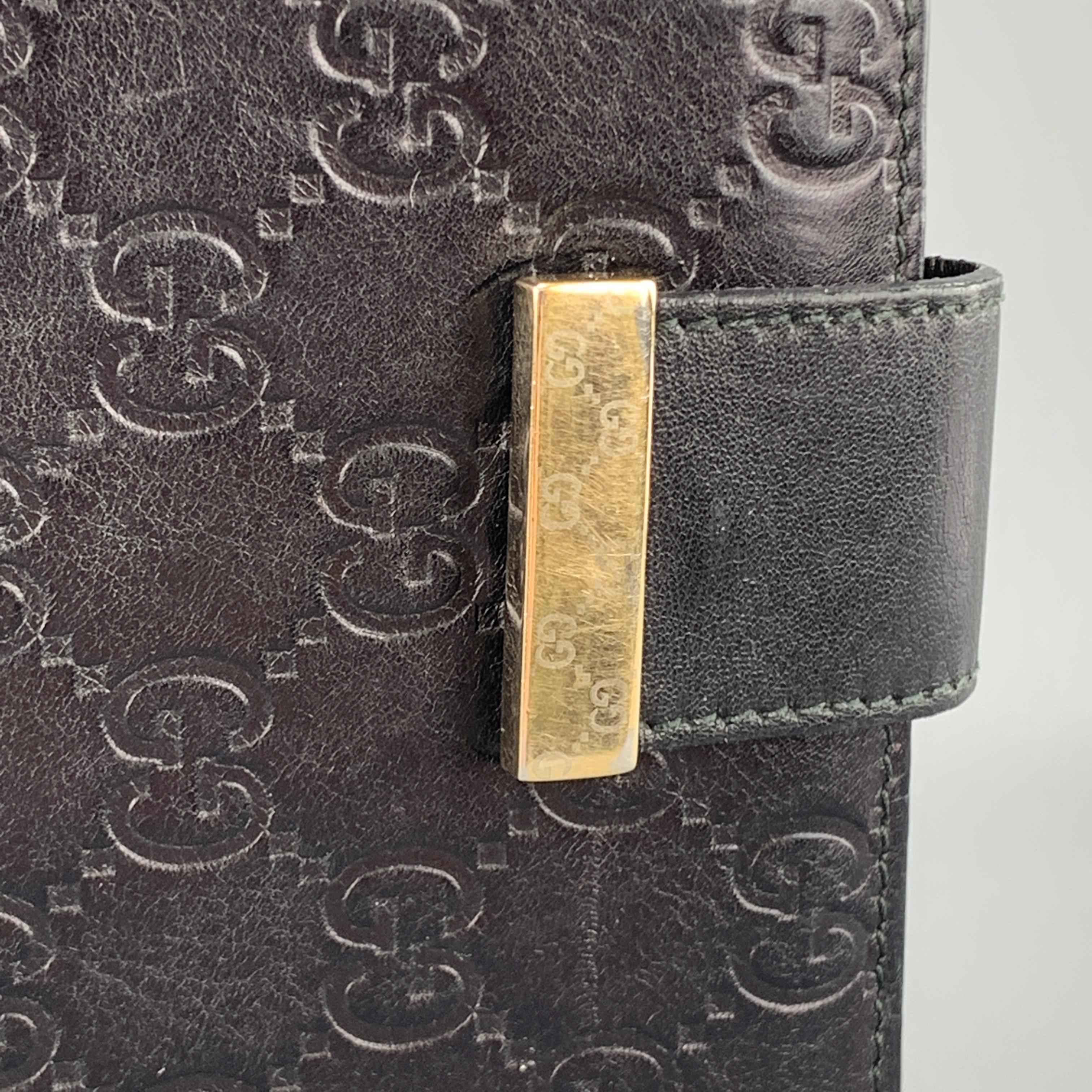 Archive GUCCI checkbook wallet comes in black Guccissima monogram embossed leather with a flap pocket back, flap front with gold tone accented tab snap closure, and internal storage. Snap is loose. As-is. Made in Italy.

Good Pre-Owned