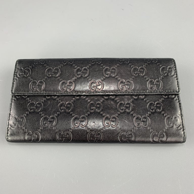 A Gucci Black Checkbook Cover, 6.25 x 3.25. sold at auction from 2nd  December to 8th December