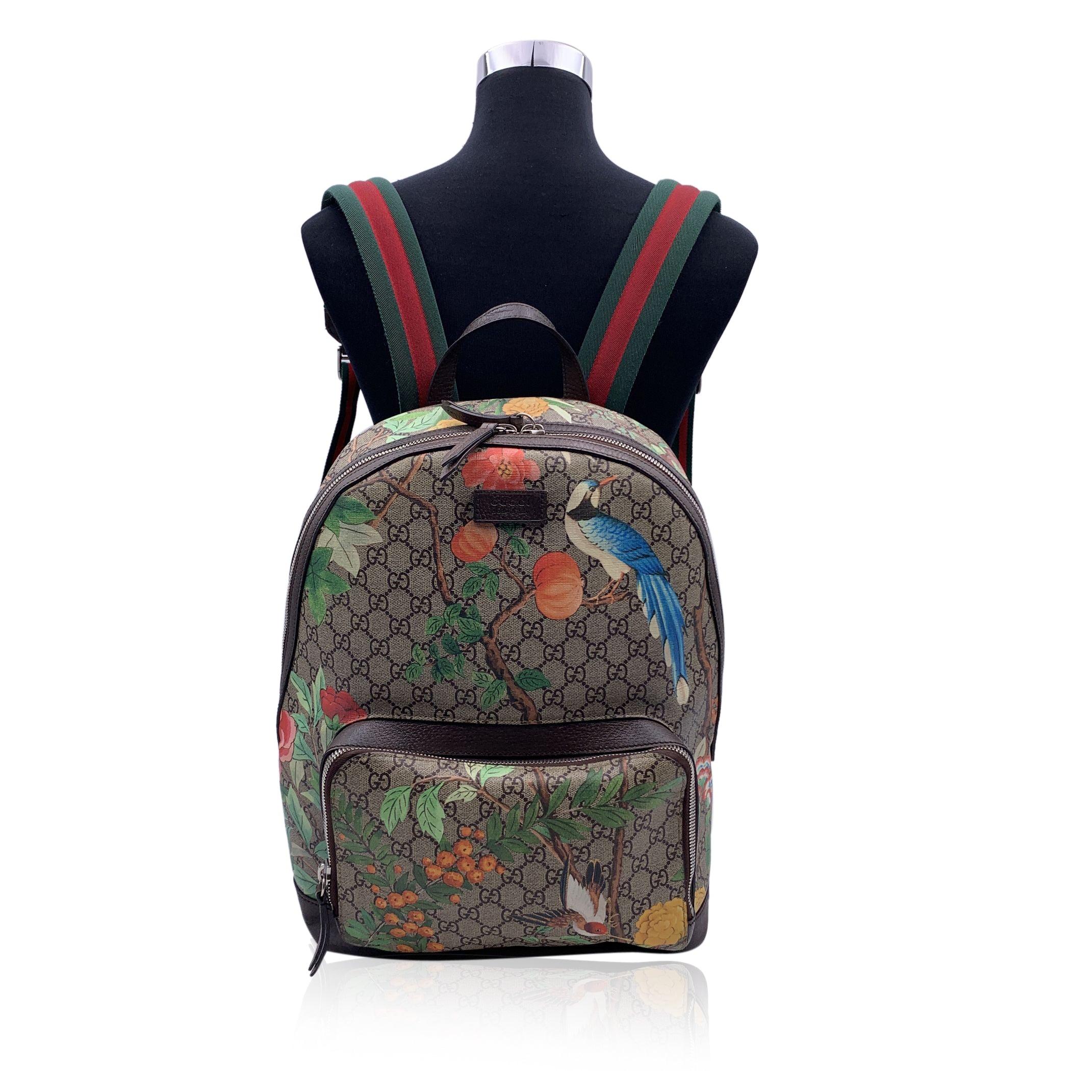 This beautiful Bag will come with a Certificate of Authenticity provided by Entrupy. The certificate will be provided at no further cost Gucci Monogram Tian Web Backpack bag, crafted of Gucci GG Supreme monogram canvas with a floral and hummingbird
