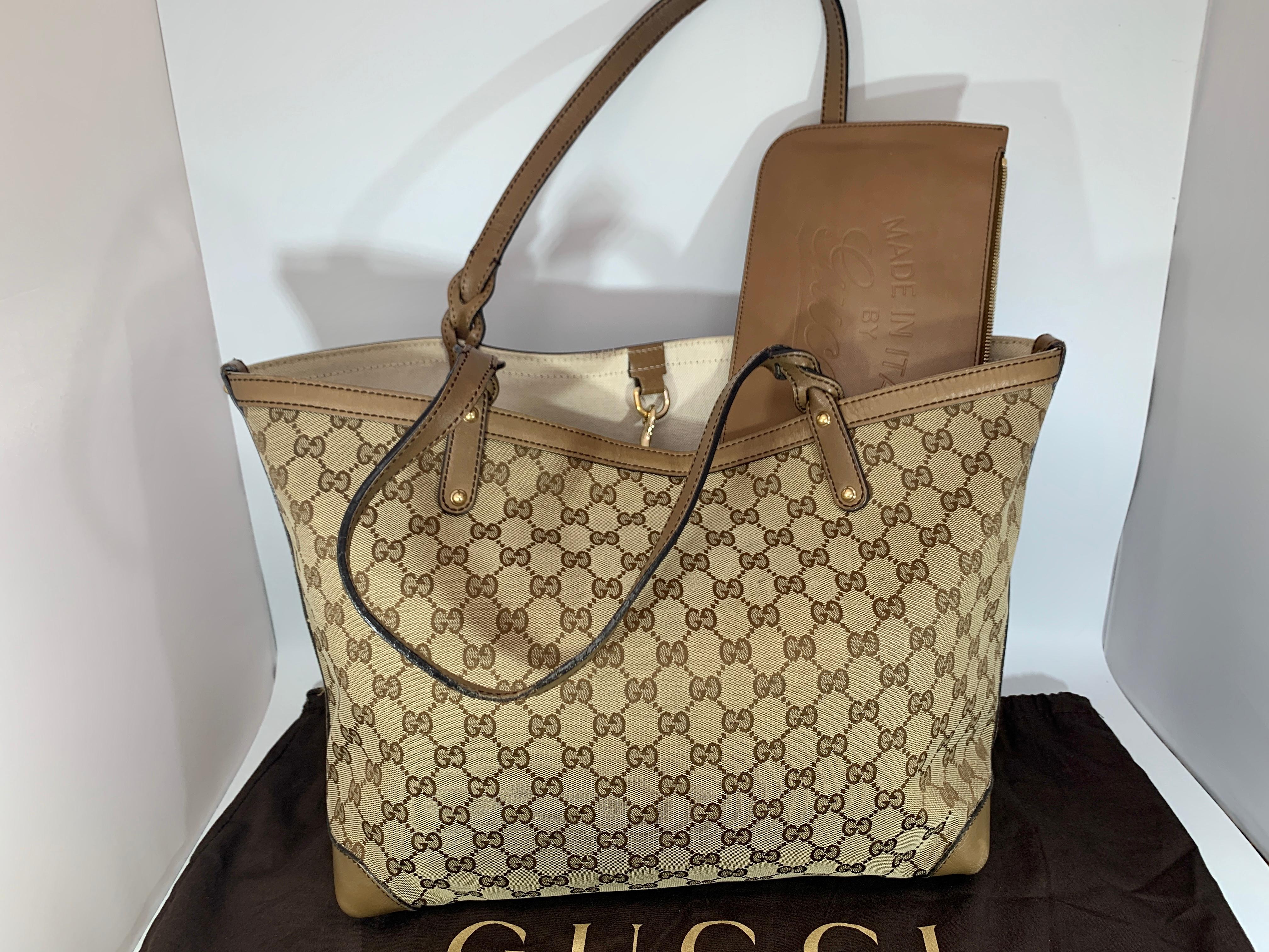 This is an authentic GUCCI Monogram Large Original Tote Tan . This chic tote is crafted of traditional brown on beige Gucci GG monogram canvas. The bag features light caramel leather details including strap top handles and corner reinforcements. The