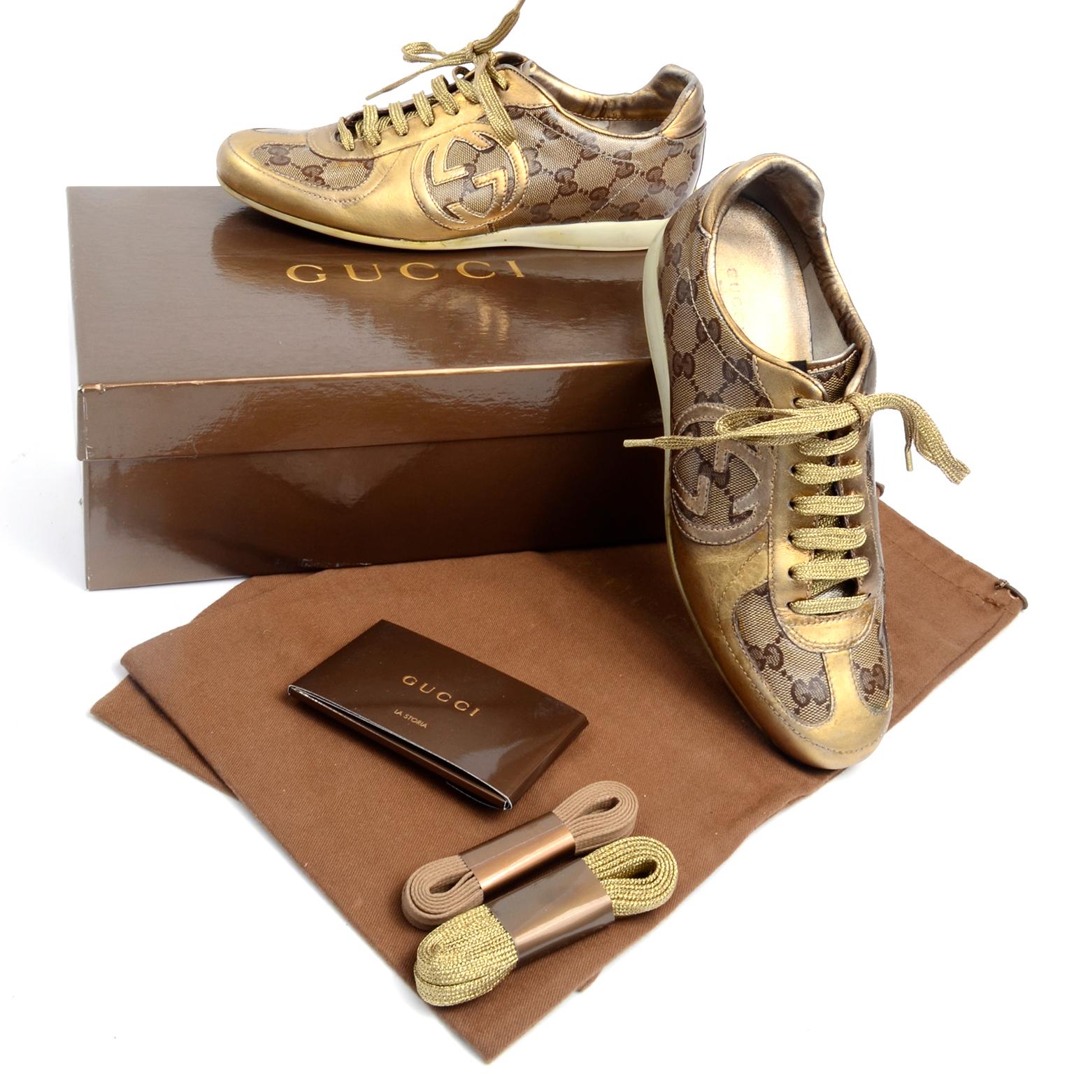 These classic Gucci trainers are in the signature Gucci monogram canvas with gold leather accents and a gold leather GG logo. The sneakers come with their original box, dust bag and 2 pair of extra shoe laces. Labeled a size 36.
Box is marked: