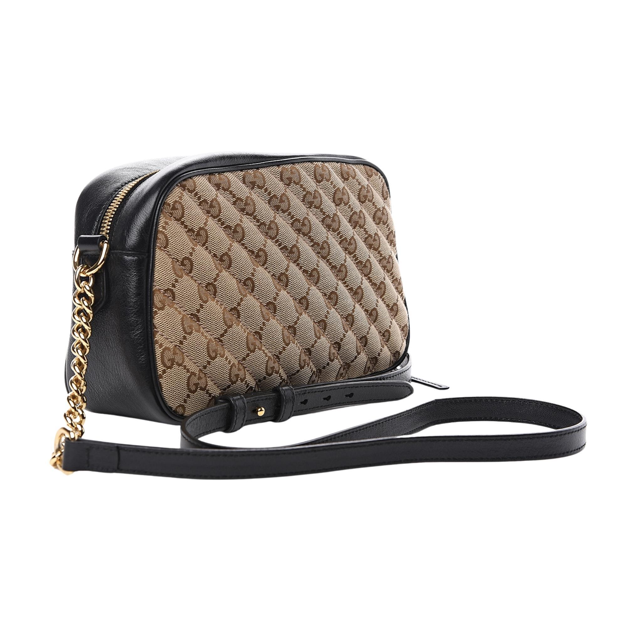 This shoulder bag is constructed with Gucci's Original GG canvas with a quilted diagonal matelassé technique and trimmed with black leather. The bag features gold-toned hardware, a chain-link shoulder strap, a black leather shoulder pad for