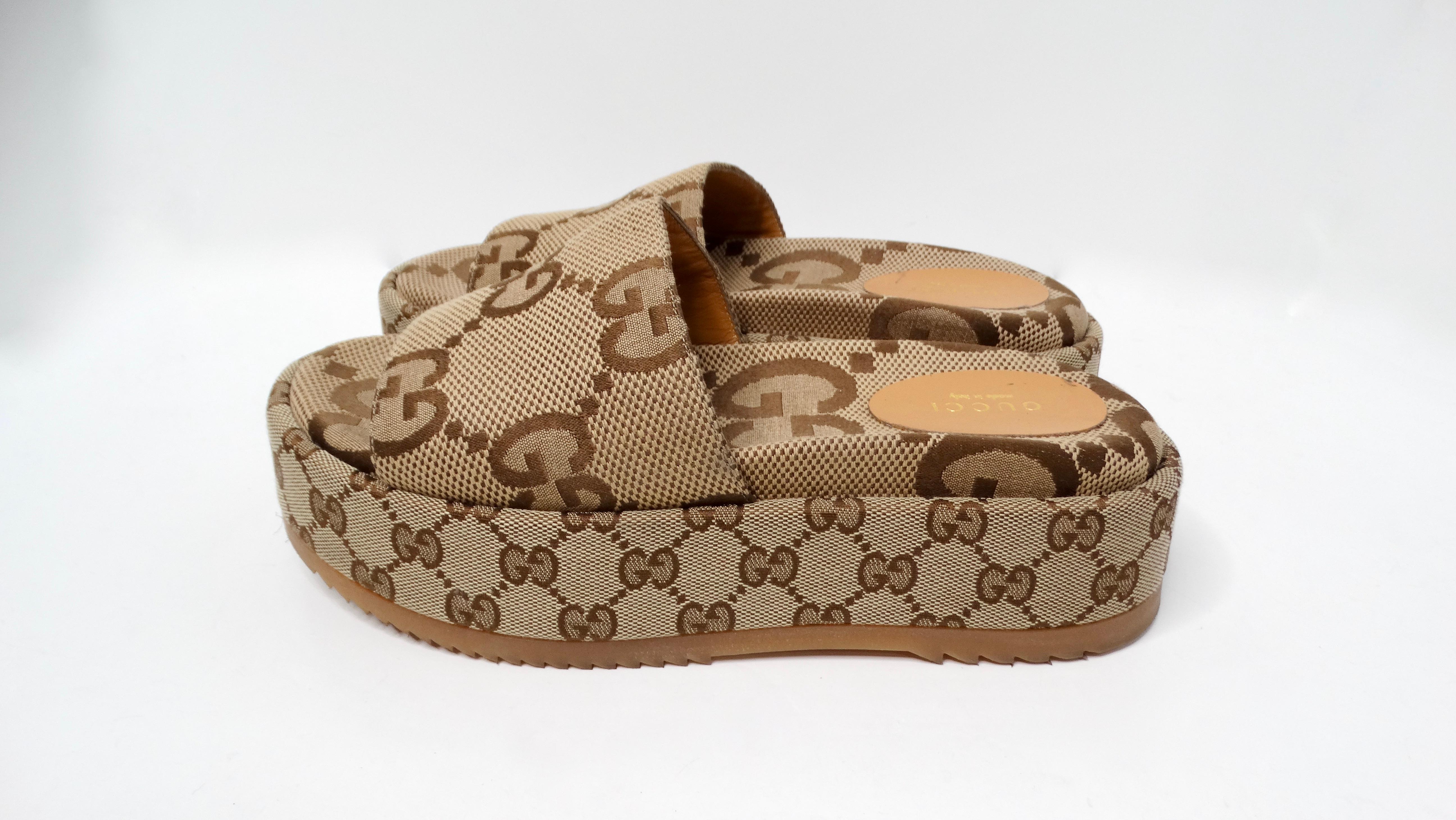 The Gucci Monogram Maxi GG Angelina Platform Slide Sandals are a striking fusion of luxury and comfort, perfect for those who appreciate high-fashion essentials. Crafted from premium brown canvas, these sandals feature the iconic Gucci monogram
