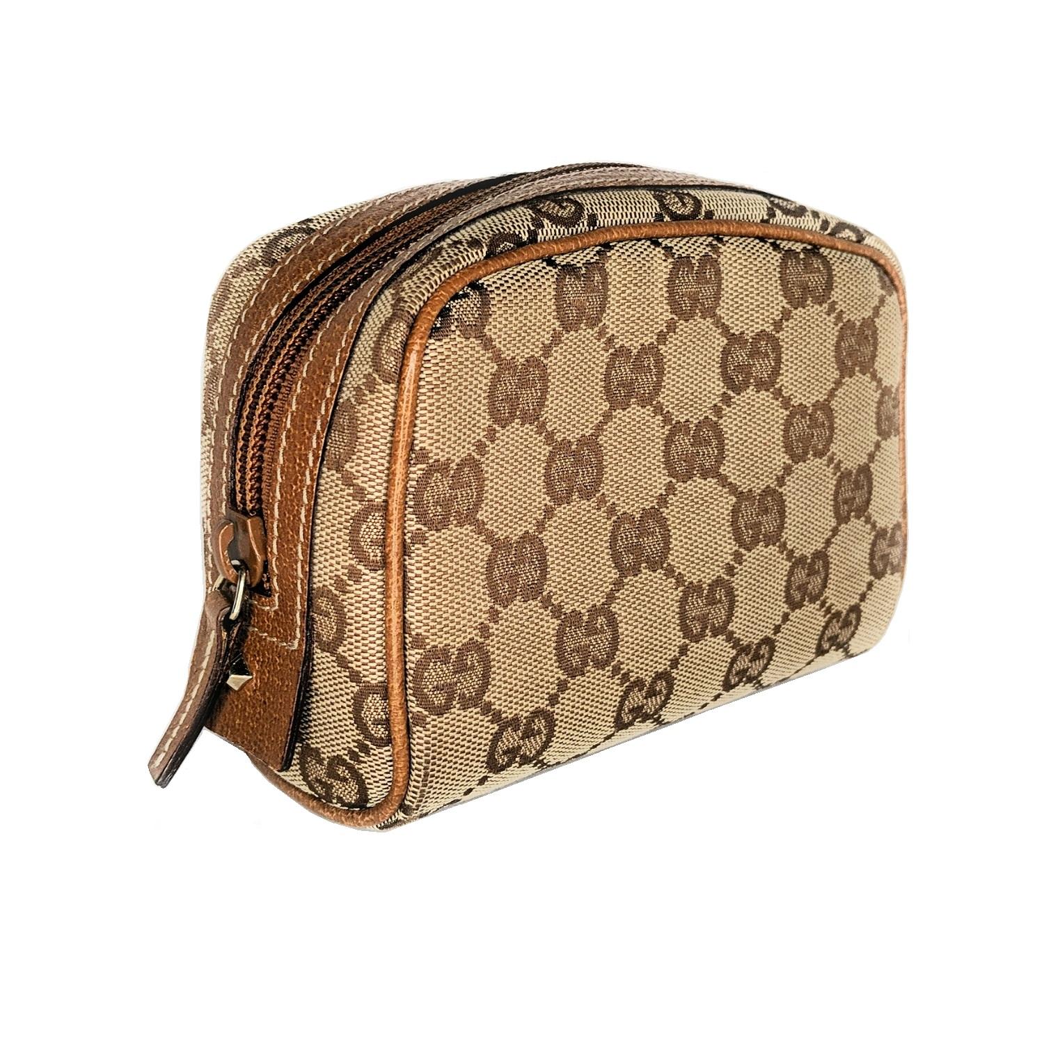 This case is crafted of classic Gucci GG monogram canvas. The case features leather trim for the top zipper with a gold-tone brass horsebit nail head. The zipper opens to a fabric interior.

Designer: Gucci
Material: GG Supreme canvas w/ leather
