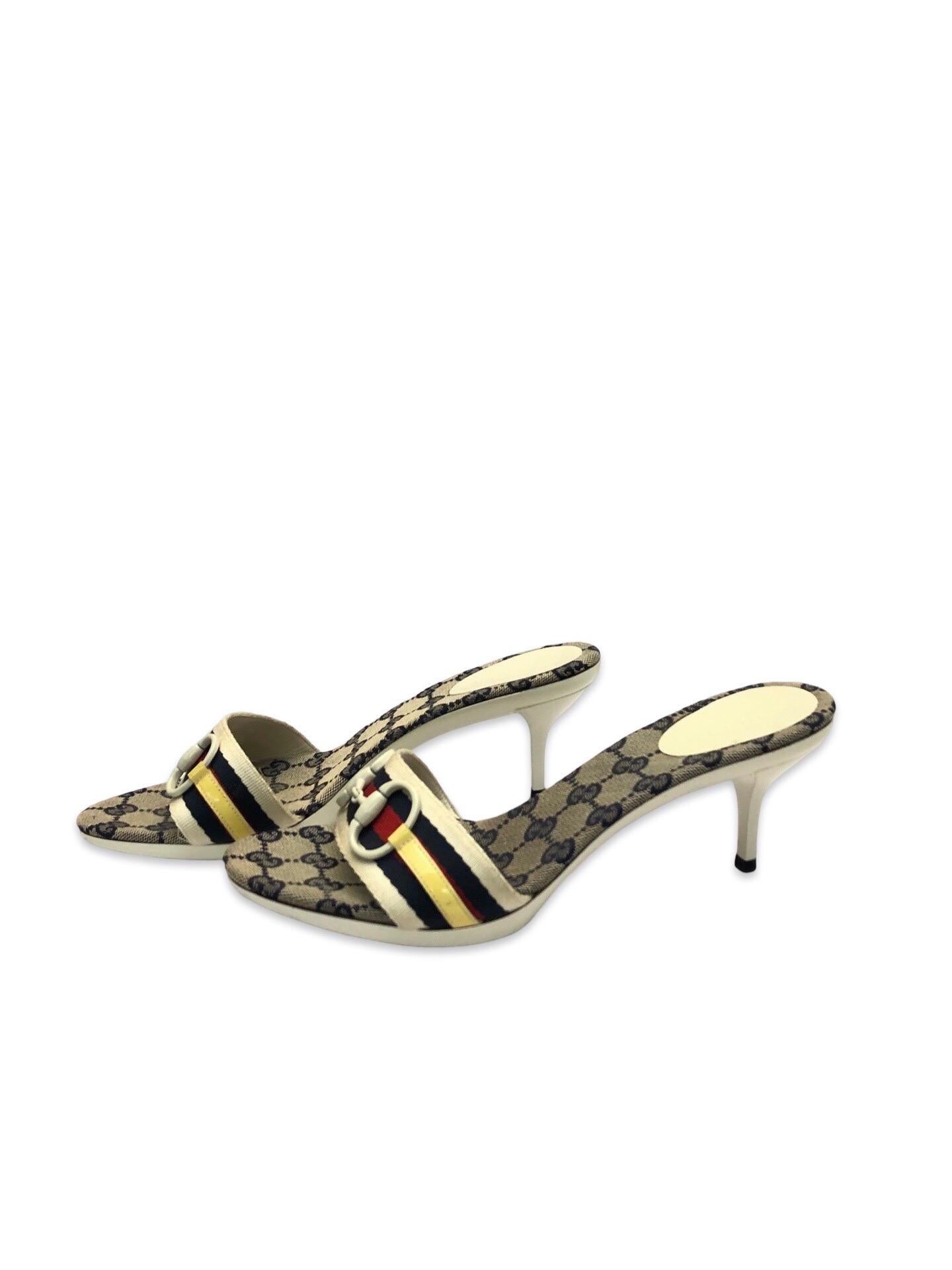 - Gucci monogram sandals heels with their signature striped band, and on top of it is a white patent stripe with white horsebit which is rarely seen to be used within the brand. 

- Size 38.5. 

