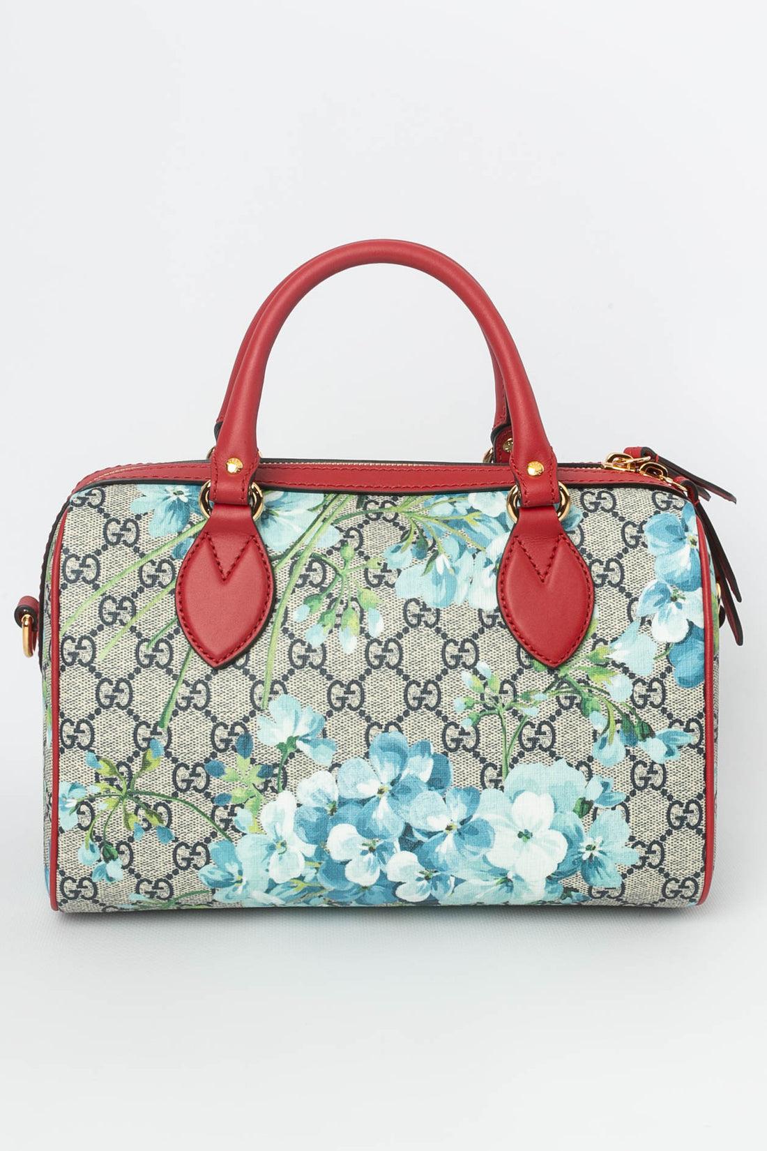 Gucci (Made in Italy) Shoulder bag in monogrammed canvas printed with floral pattern. Red leather and gilded metal hardware. The inside, lined with suede, features a zipped pocket and two patch pockets.

Additional information: 

Dimensions: 
Width: