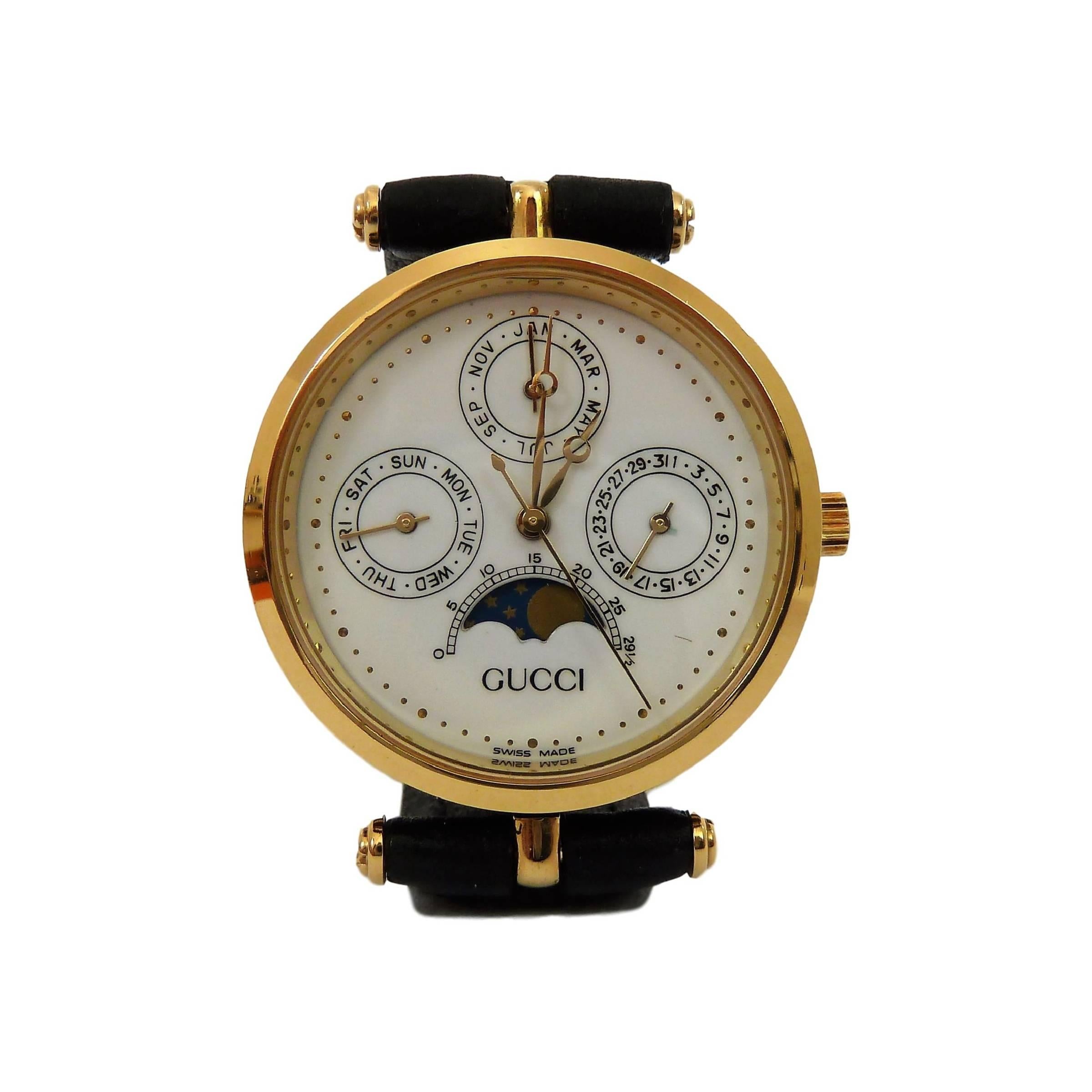 Gucci moon phase vintage watch 1980s. Black detail against satin white tapestry-patterned face, stainless steel case, fancy lugs, crown & clasp, enamelled glass back, original brown leather band. It has a pointer-triple-calendar, which displays