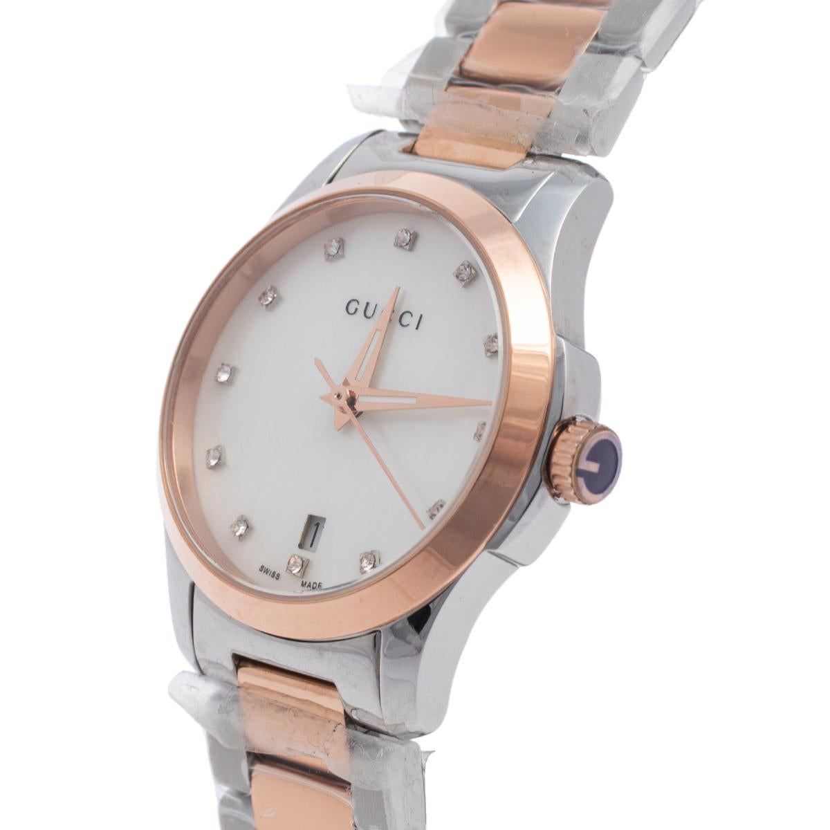 Gucci brings you this smart two-tone stainless steel timepiece for you to flaunt on your wrist. Swiss-made, it follows a quartz movement and carries a mother of pearl dial. It has a date window, stud hour markers, and three hands within the case.