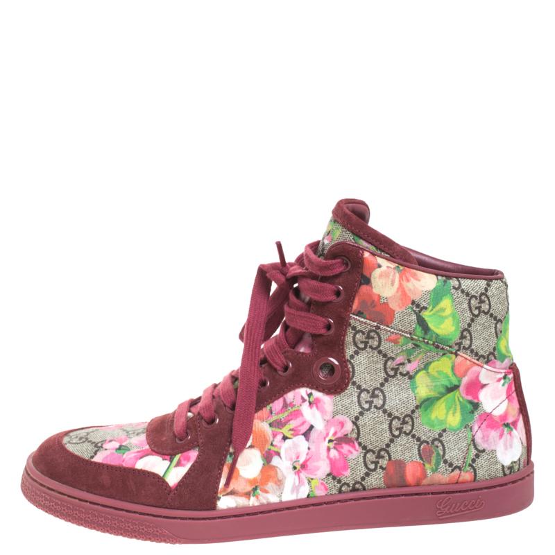 Created to provide comfort and designed to fetch onlookers, this pair of high top sneakers by Gucci is absolutely a worthy buy. The sneakers have been crafted from GG coated canvas and designed with round toes and lace-ups on the vamps. They flaunt