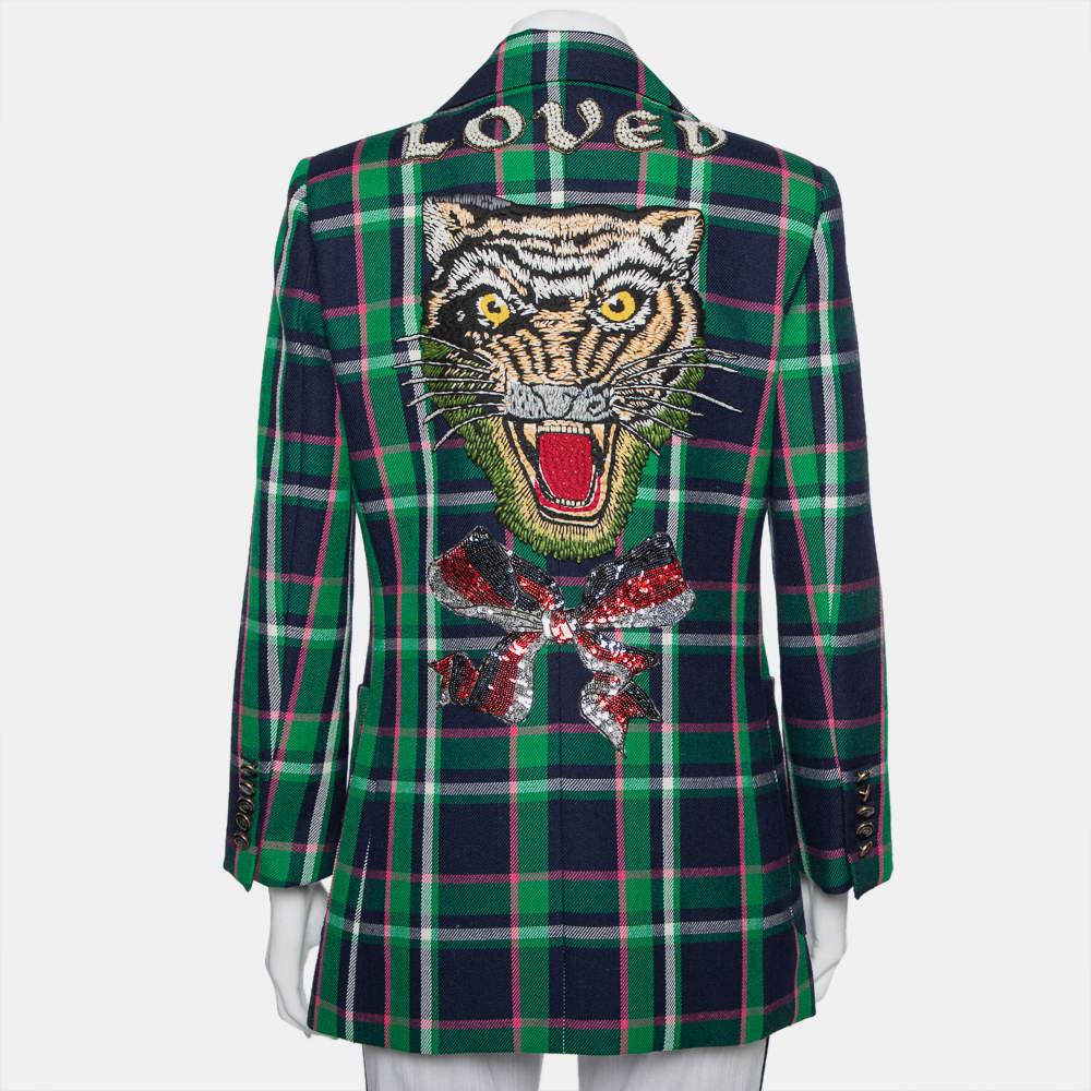 With such a chic and smart blazer, you are sure to make a statement! This multicolor Gucci creation is made of wool and designed with a checkered pattern all over. It flaunts peak lapels, front button fastenings, an embroidered tiger, bow, and