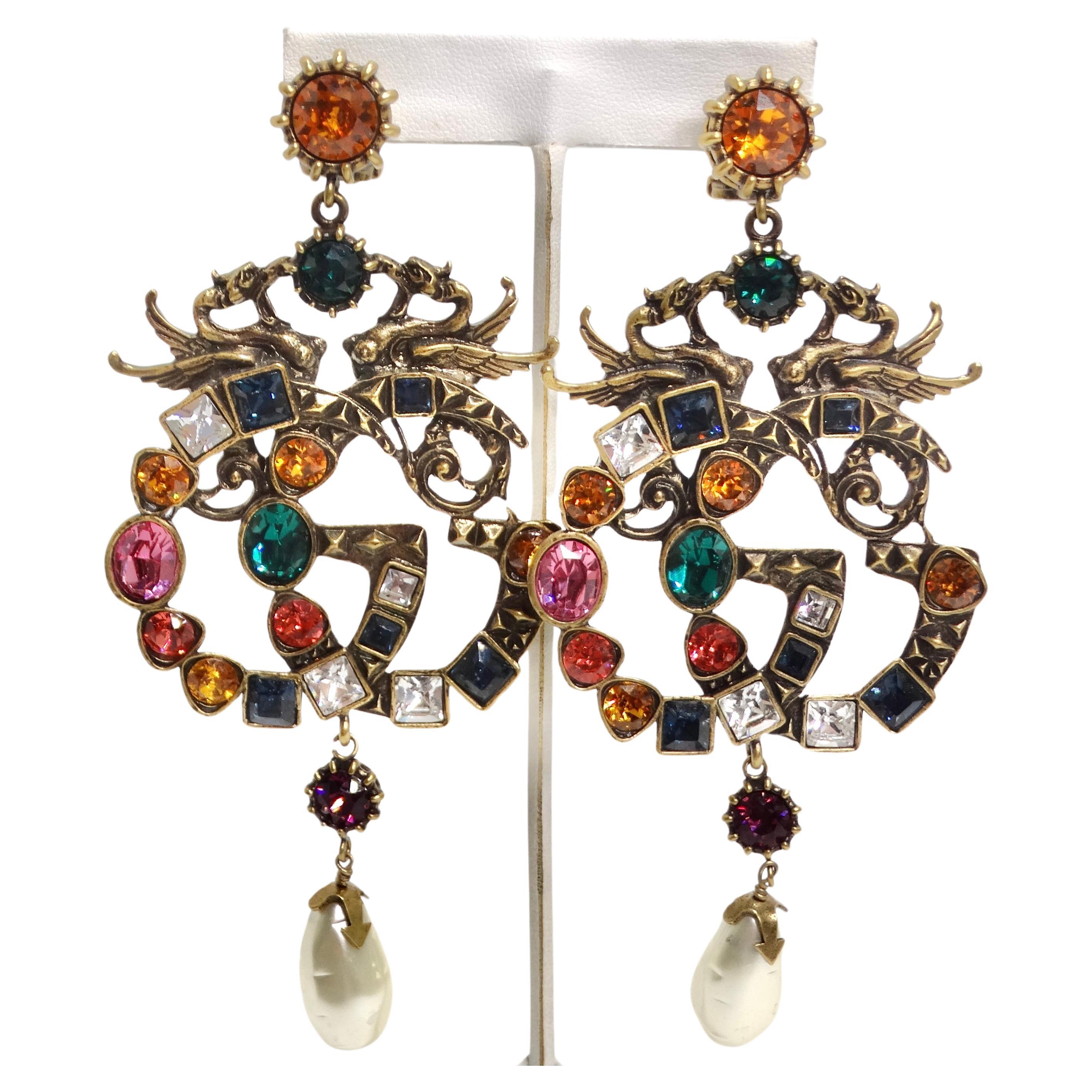 Introducing the Gucci Multicolor Crystal Faux Pearl Logo Earrings, a stunning pair that effortlessly combines luxury and creativity. These earrings are more than just accessories; they are works of art that make a bold statement. These earrings