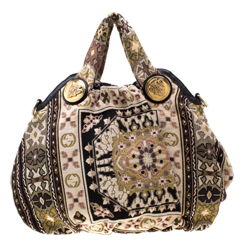Flattering in a contemporary design is this Hysteria hobo from Gucci. The hobo has been meticulously crafted from multicolor embroidered tapestry fabric and is accented with Gucci’s iconic gold-tone crests. The bag features dual top handles, a