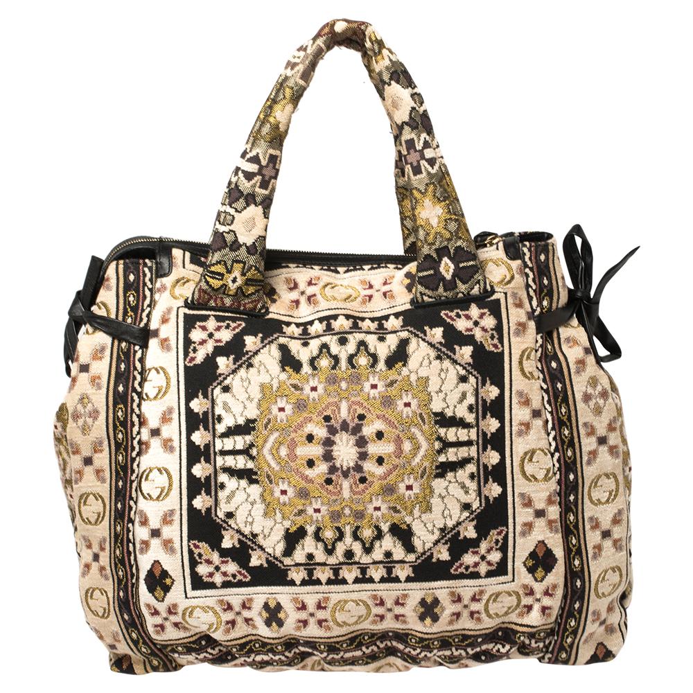 This Gucci tote is built for everyday use. Crafted from tapestry fabric, it has a multicolored exterior and two handles, and intricate embroidery that exudes a bohemian charm. The nylon and leather insides are sized well and the bag is complete with