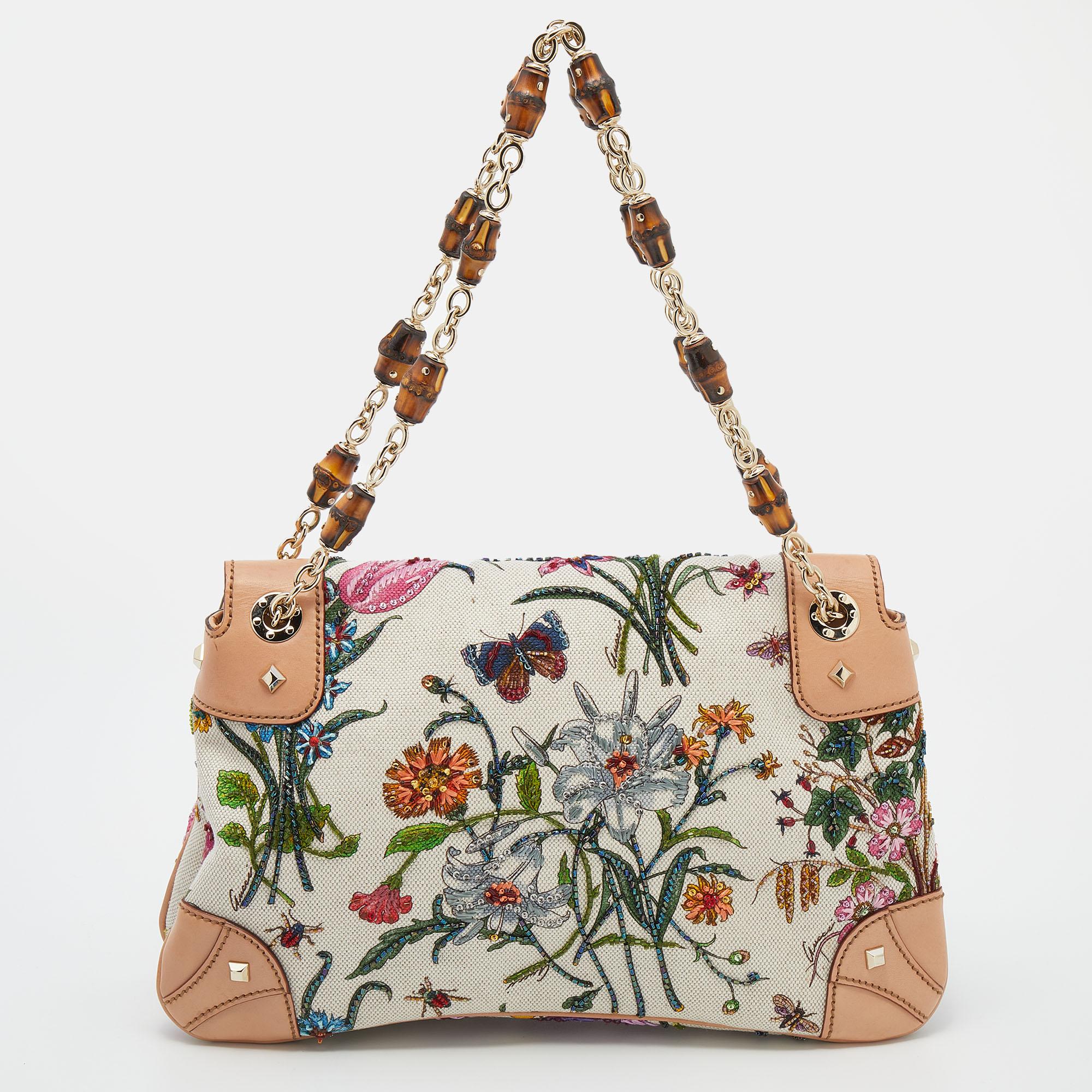 From the Spring/Summer 2013 collection comes this Gucci Bamboo shoulder bag, it's made from floral printed canvas with leather trims and has dual beaded handles. The flap bamboo closure opens to a spacious interior.

Includes: Info Booklet, Original