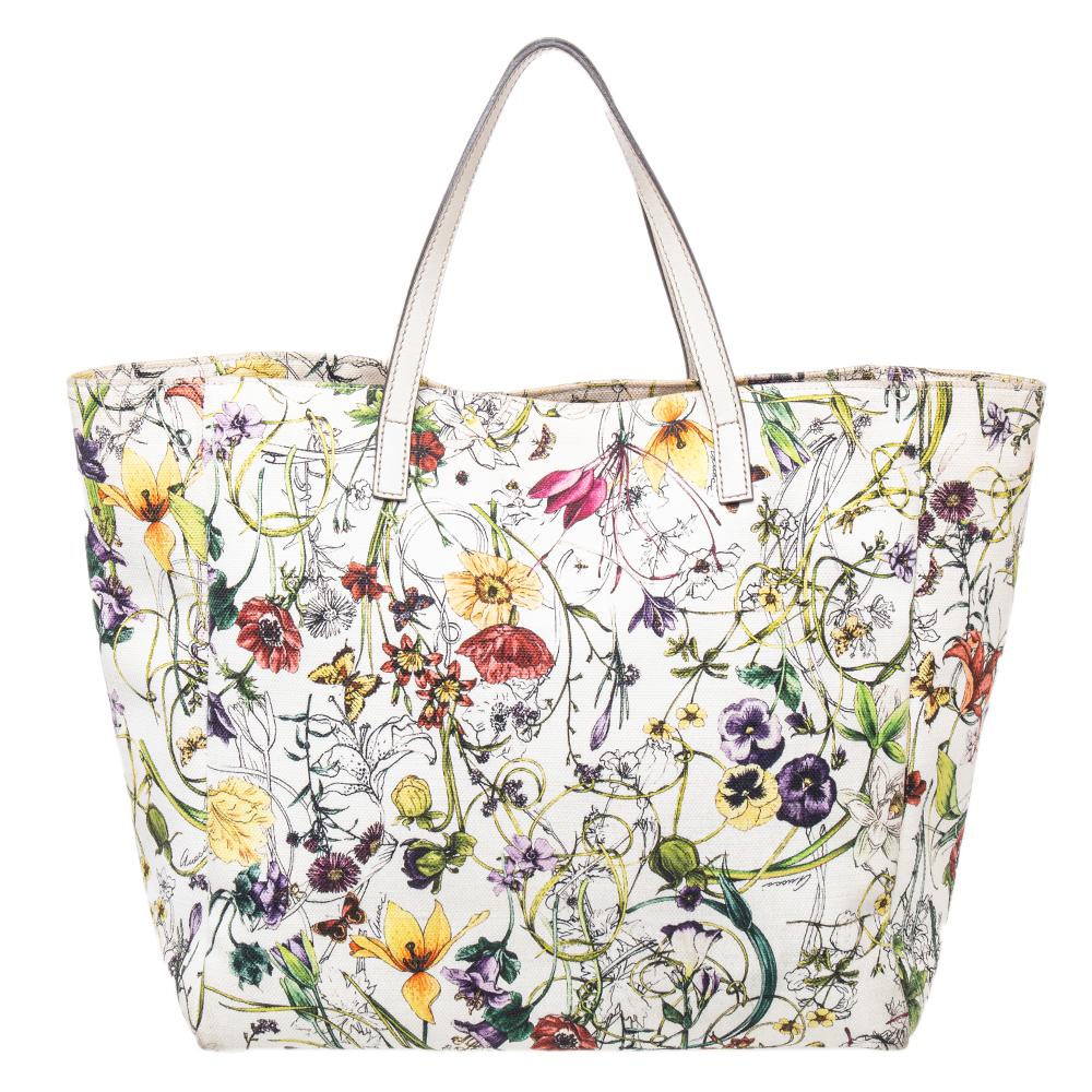 Gucci brings to you this amazing tote that is smart and very modern. Made in Italy, this bag is crafted from floral-printed canvas and leather and features dual top handles. The canvas-lined interior is sized to hold all your daily essentials. The