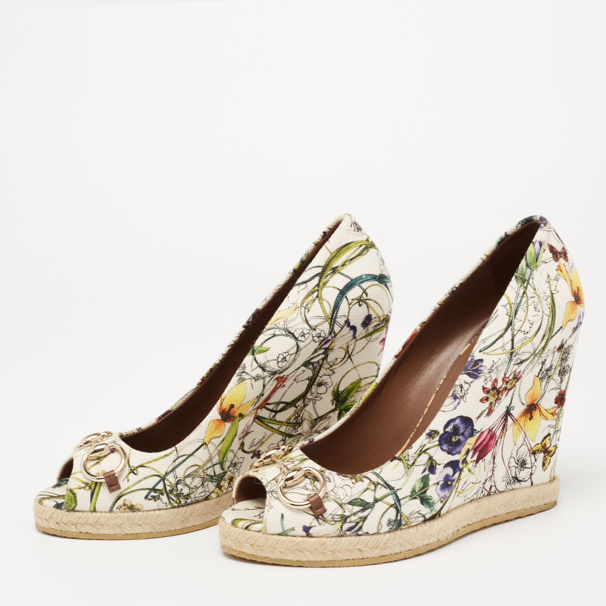 These wedge pumps from Gucci are crafted from canvas in a multicolored, floral print. They feature the signature Horsebit accents on the vamps, smooth insoles, and durable rubber soles for a comfortable walk.