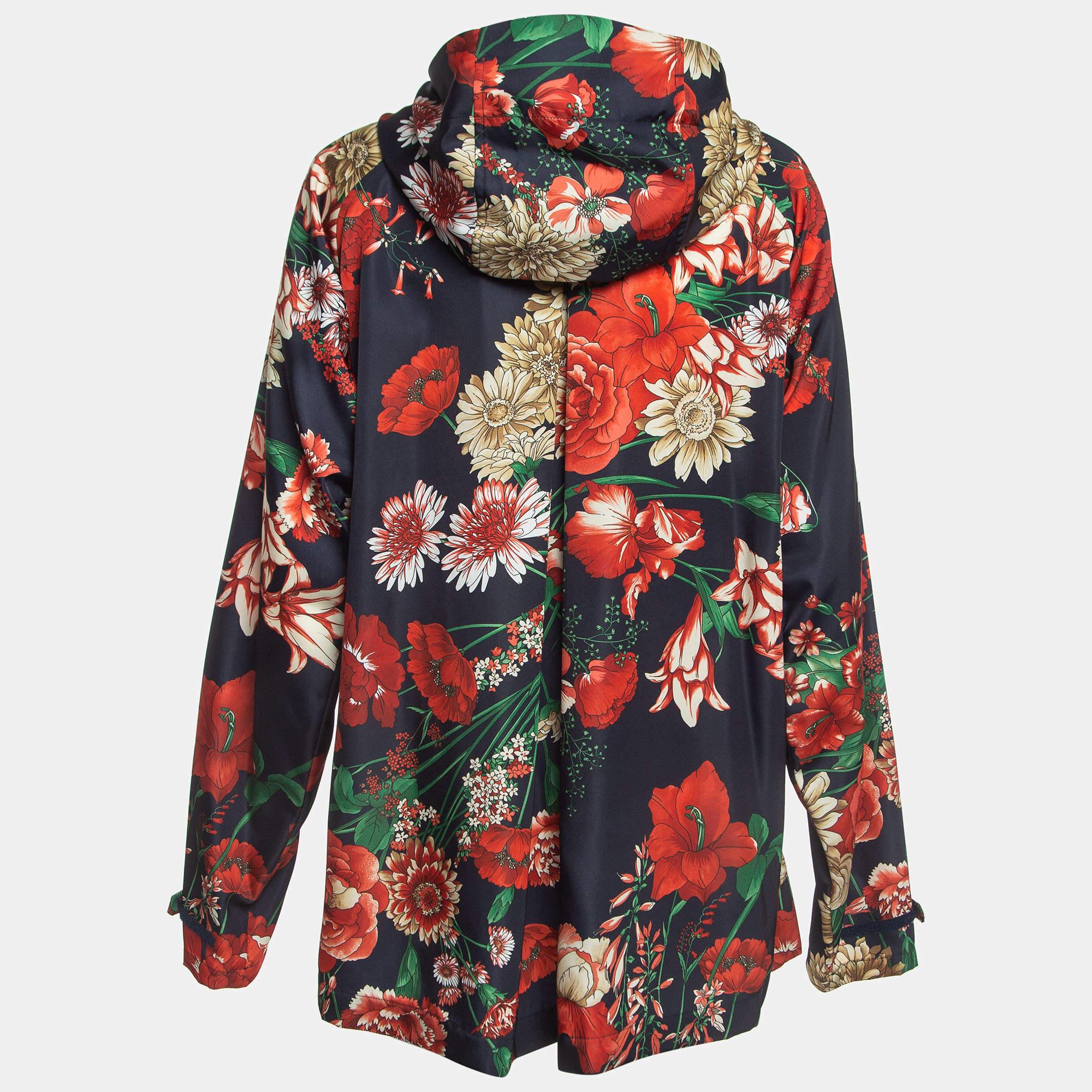 The Gucci jacket is a vibrant and stylish outerwear piece. Crafted from high quality nylon it features a striking floral print design with intricate applique detailing complete with a cozy hood for added comfort and flair.