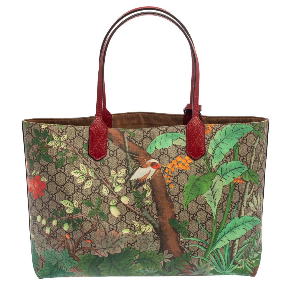 This beautiful tote by Gucci is rendered in GG supreme canvas featuring the Tian garden print influenced by Chinese landscapes depicted on 18th-century tapestries that showcases colorful birds and delicate flowers. The bag is held by two handles and