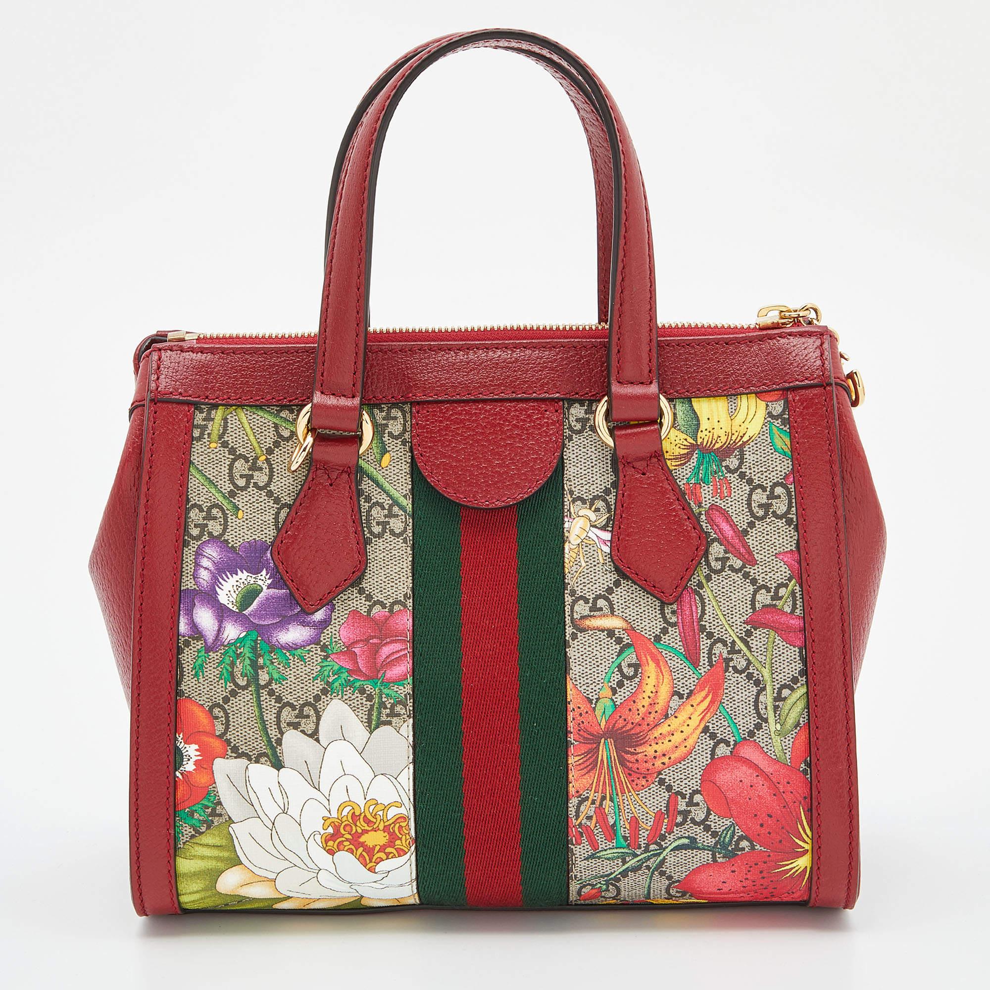 Crafted from GG Supreme canvas and leather, this Gucci Ophidia bag comes in a compact shape for a sophisticated look. It features the iconic Web stripe, Flora prints, and the GG motif—all Gucci codes. The bag suspends from two handles and a slender