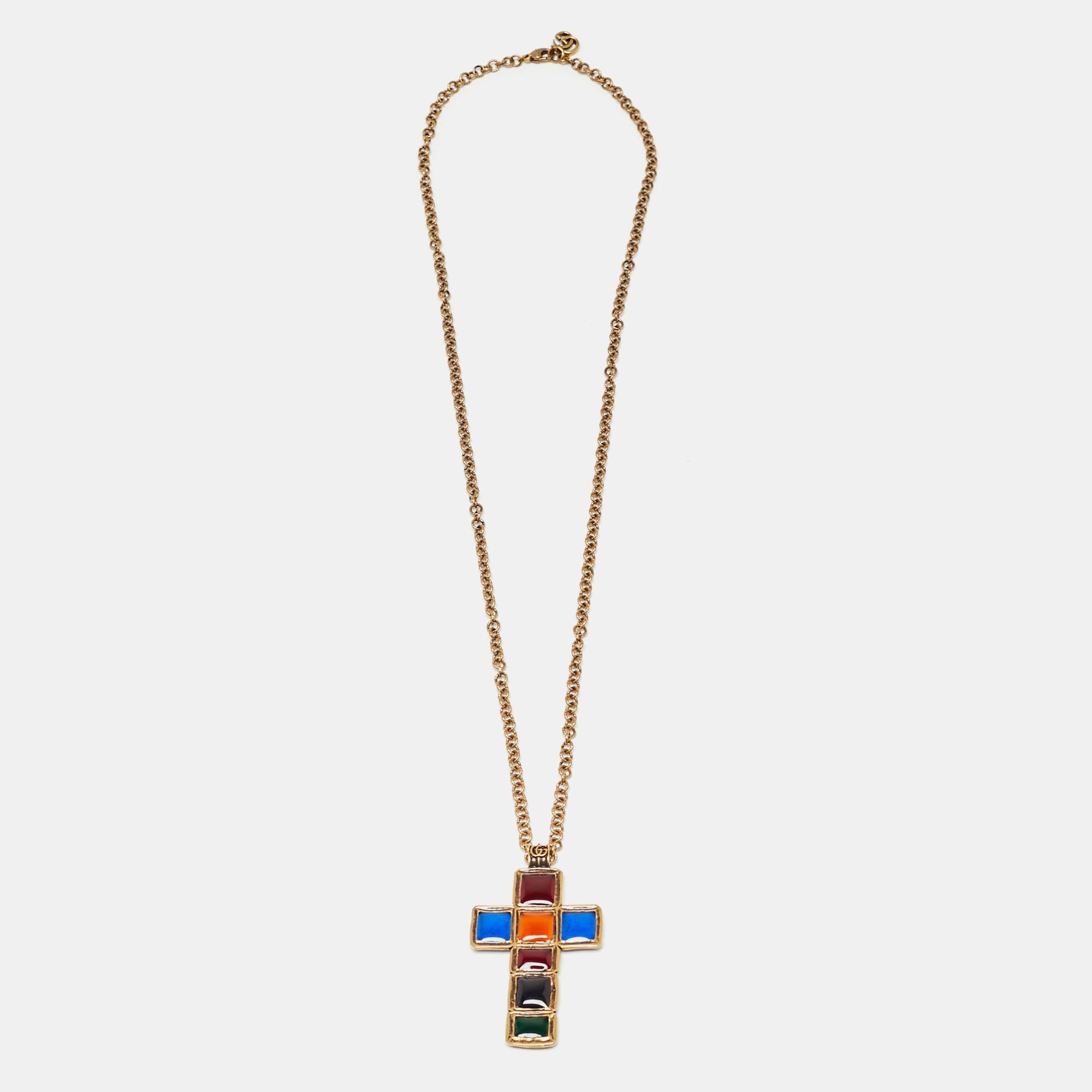 This beautiful necklace from Gucci is effortlessly chic and perfect with both a day and evening look. Made of gold-tone metal, it has a cross pendant set with colorful gripoix.

Includes: Original Dustbag, Original Box,
