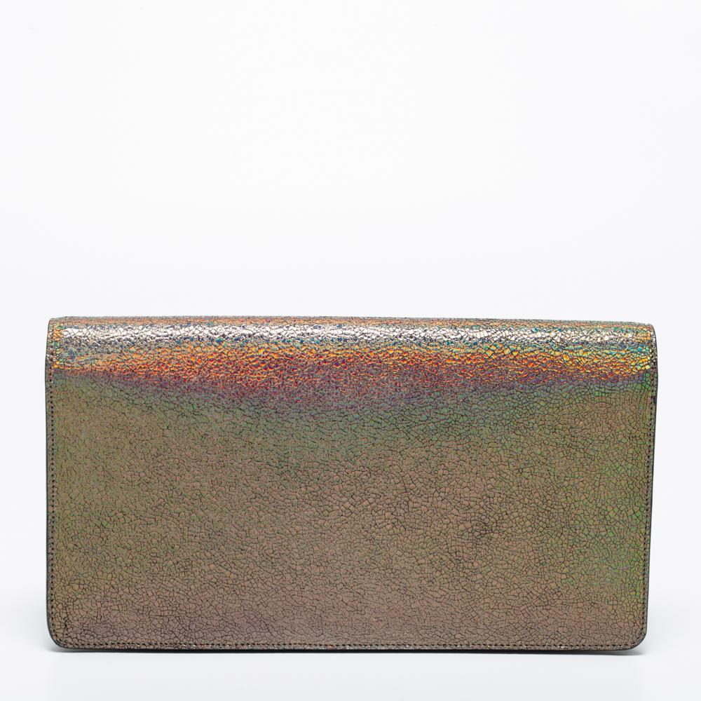 This clutch from Gucci has an appealing design, perfect to complement an evening dress or a day ensemble. It is crafted from holographic crackled leather and gold-tone metal.

Includes: Original Dustbag