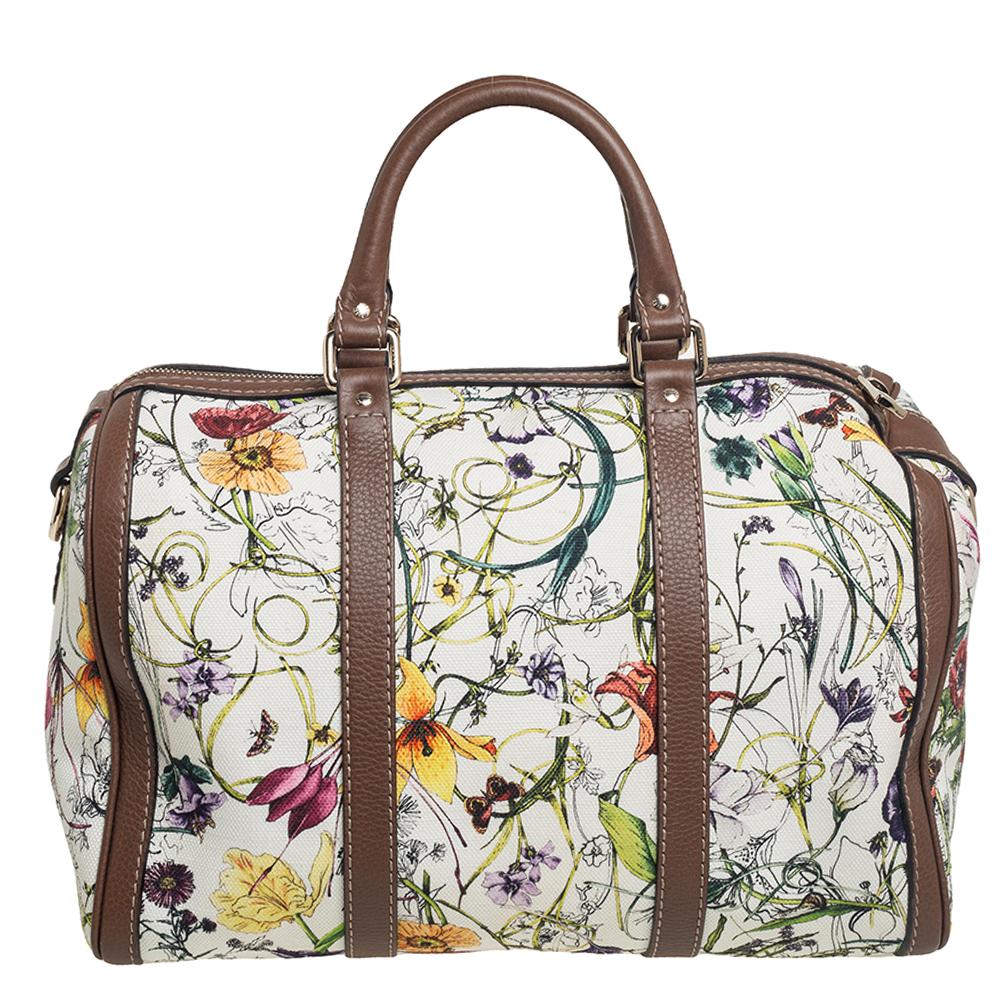 Vintage and girly, we love this Gucci Boston Bag! Crafted from Infinity floral print canvas, this bag is adorned with brown leather detailing. It features double top handles, an adjustable and removable shoulder strap, top zip closure, and gold-tone