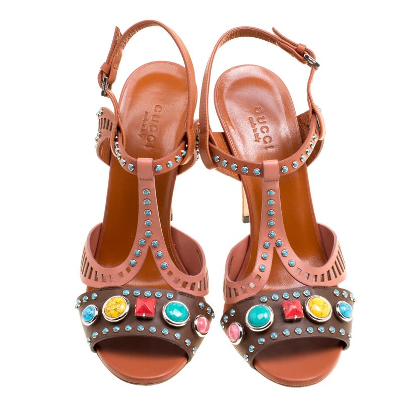 Touch the skies or make the streets your fashion runway, for these Gucci sandals are anything but ordinary! They are crafted from leather and feature an open toe silhouette. They flaunt gorgeous multicolour stones embellished on the vamp straps and