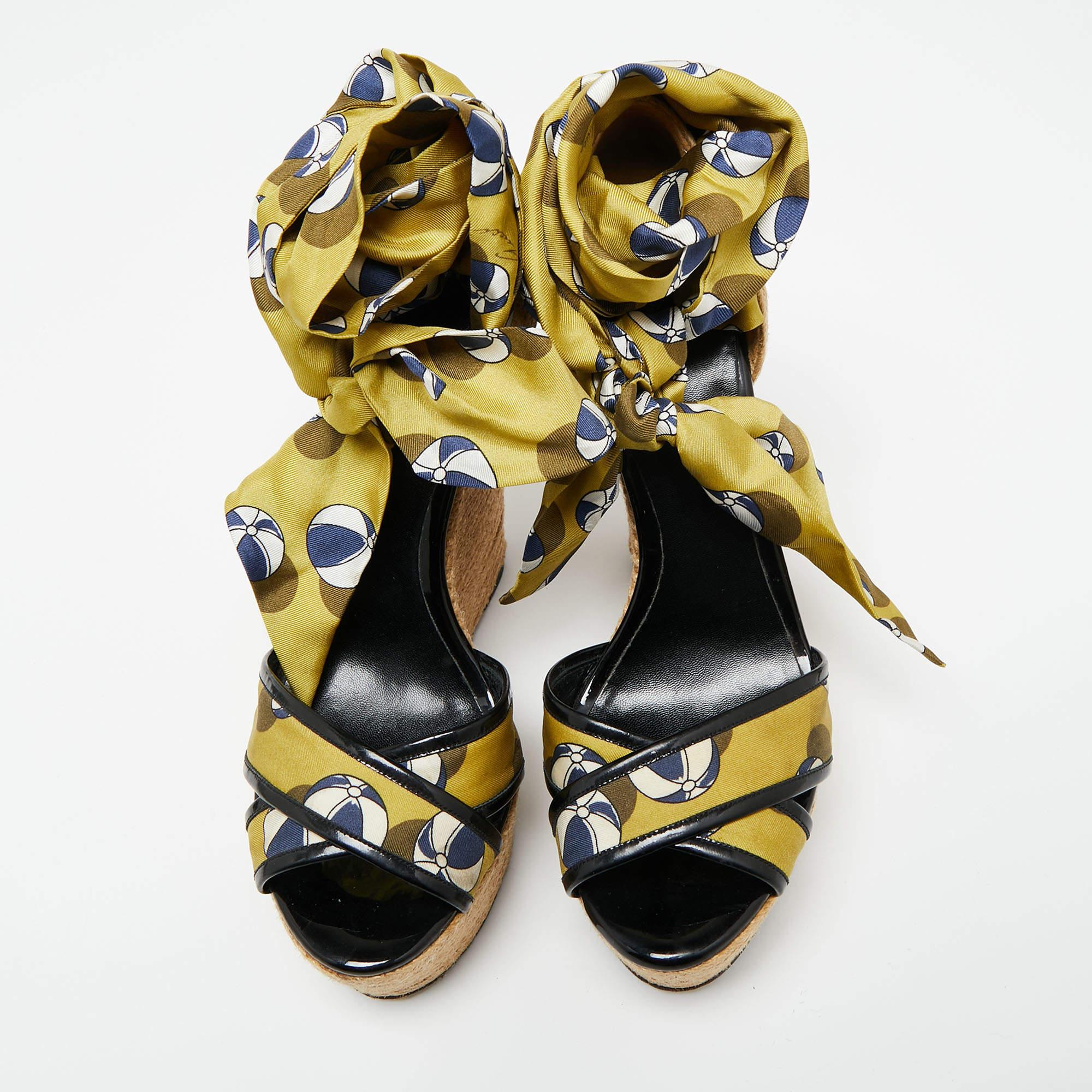 Stay comfortable throughout the day in these sandals by Gucci. Crafted to deliver drama and style, these stunning wedge sandals feature multicolored silk straps and ankle wrap detailing. They have an open toe silhouette, sturdy soles, and 15 cm