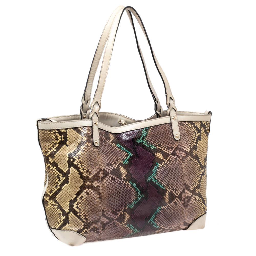 How attractive is this multicolored tote from Gucci! Exquisitely crafted from python skin and leather, it has a luxurious design with gold-tone hardware. It is finished with dual handles and a spacious interior to hold your essentials.


