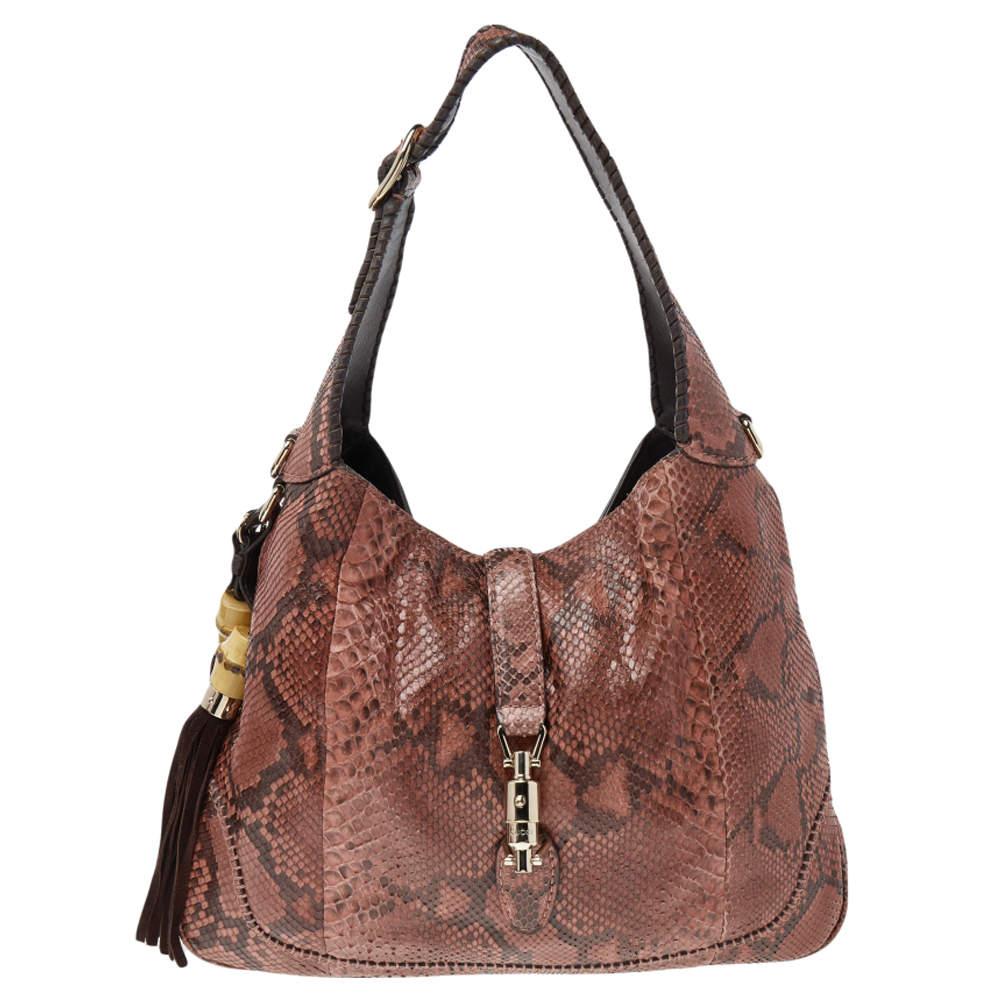 A handbag should be not only good-looking but also durable, just like this pretty Jackie hobo from Gucci. Crafted in Italy and made from exotic python & leather, this gorgeous bag comes with tassel detailing. This creation has a spacious