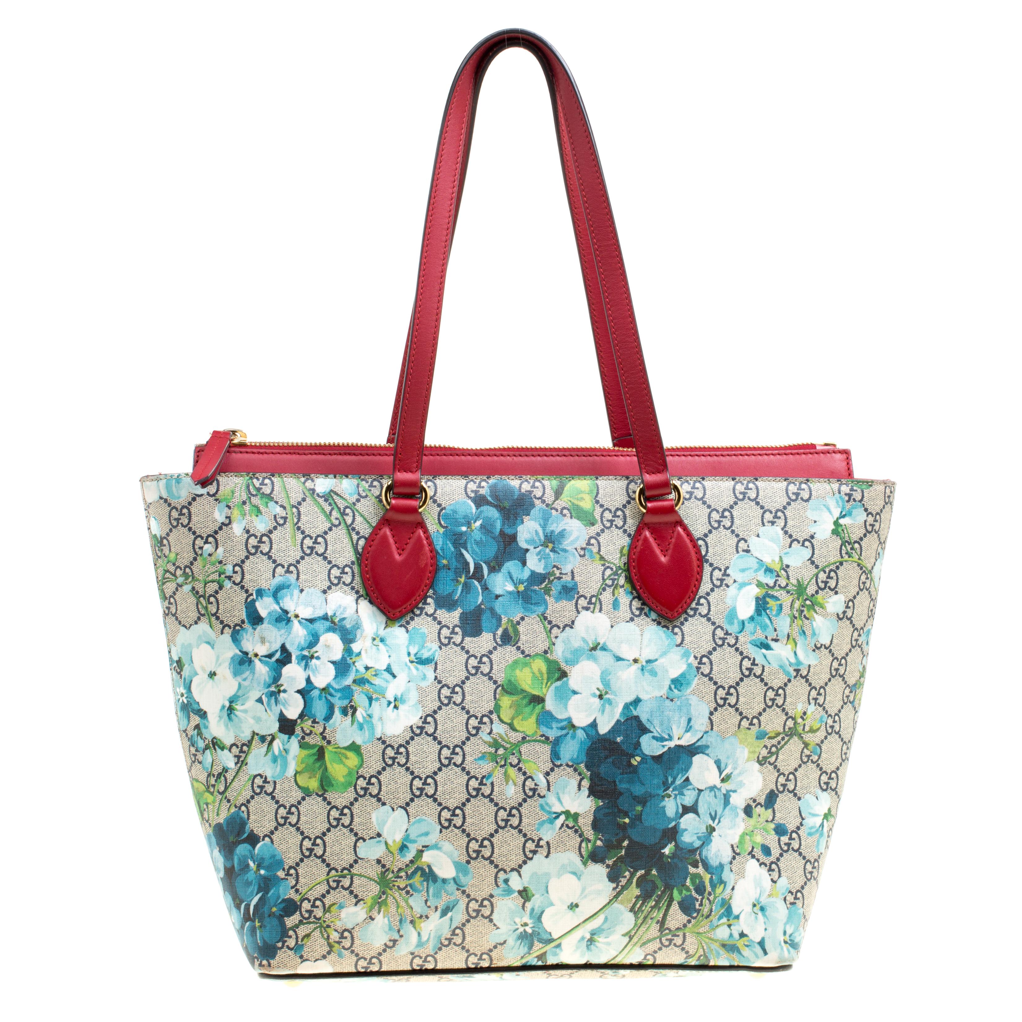 Formed using Supreme canvas and leather, this Gucci bag has prints of blooming flowers. It has two handles and a spacious suede interior. Made to an excellent finish, this tote will seamlessly blend with your grand style.

Includes: Original