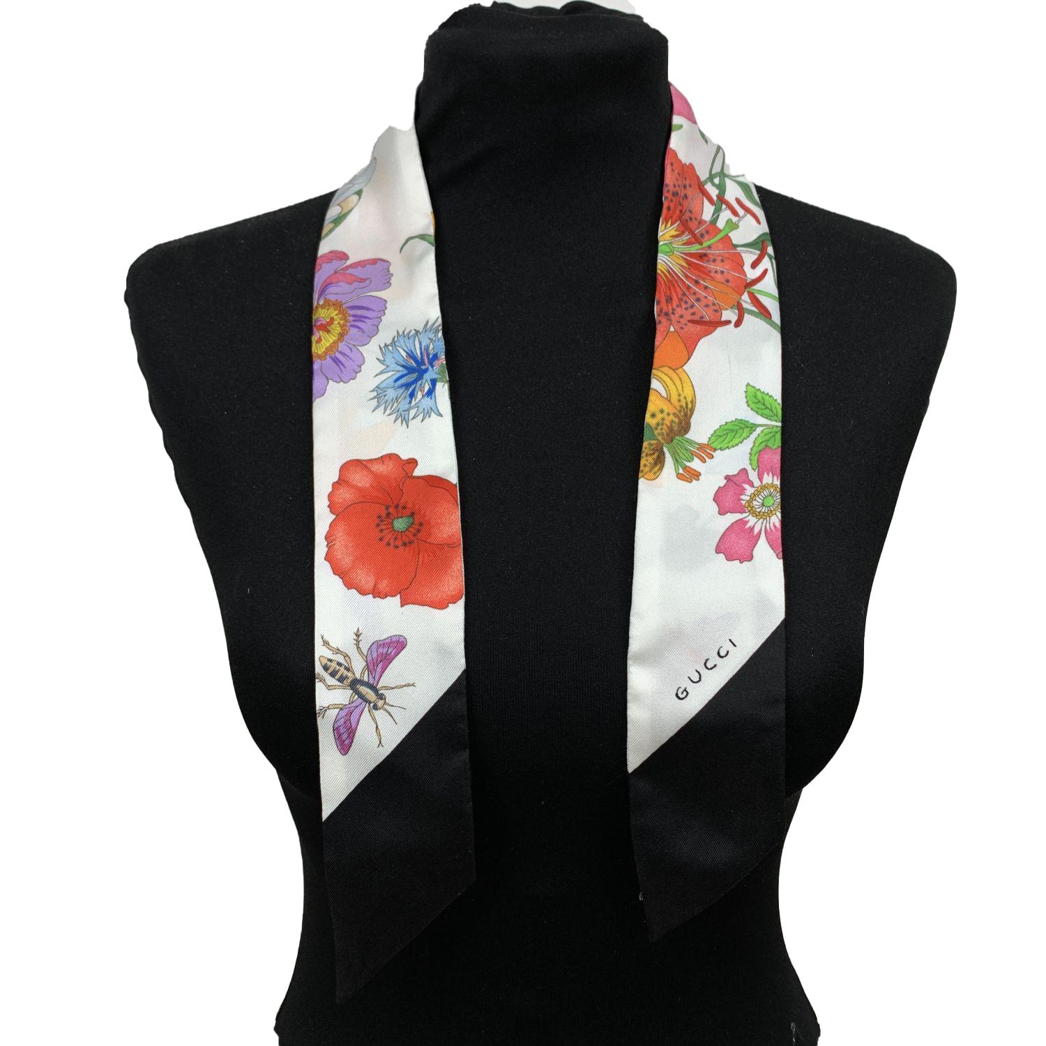 Gucci Silk Flora Twilly scarf. Multicolor floral design on white background. Black borders. Composition: 100% Silk. Total length: 33.5 inches - 85 cm. Width: 2 inches - 5,2 cm

Details

MATERIAL: Silk

COLOR: Multicolor

MODEL: Flora Twilly

GENDER: