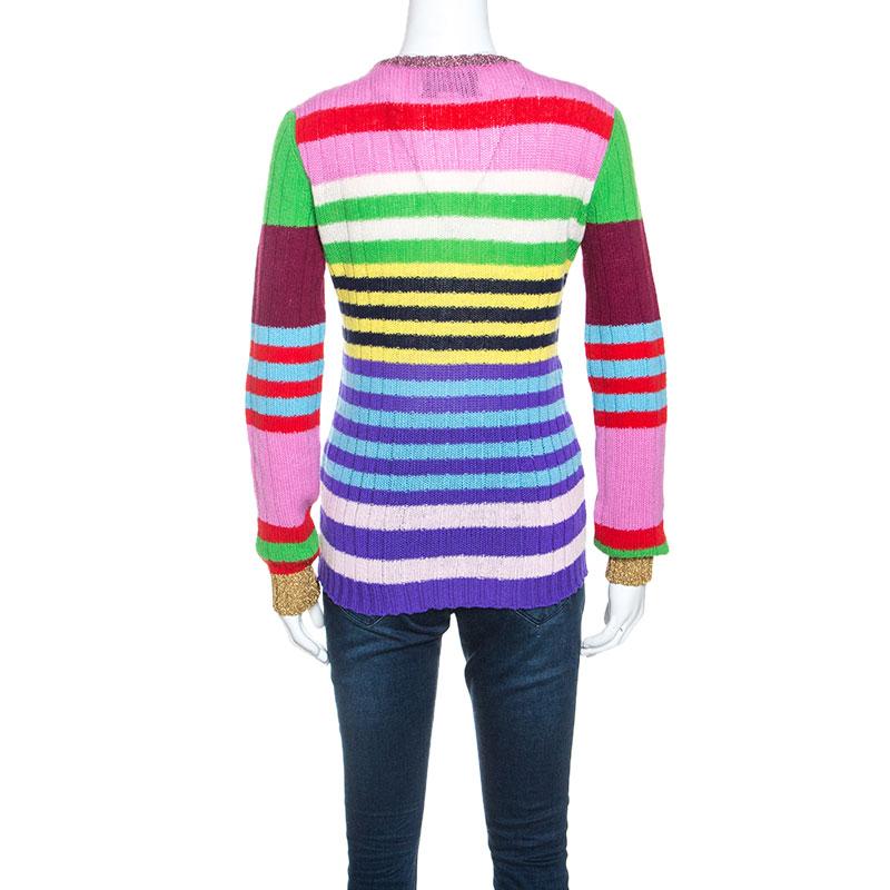 This showstopping sweater designed by Gucci is sure to make a statement. Crafted from a cashmere blend, this sweater features multicolored stripes throughout. It is further adorned with floral appliques which add interest. It flaunts a simple