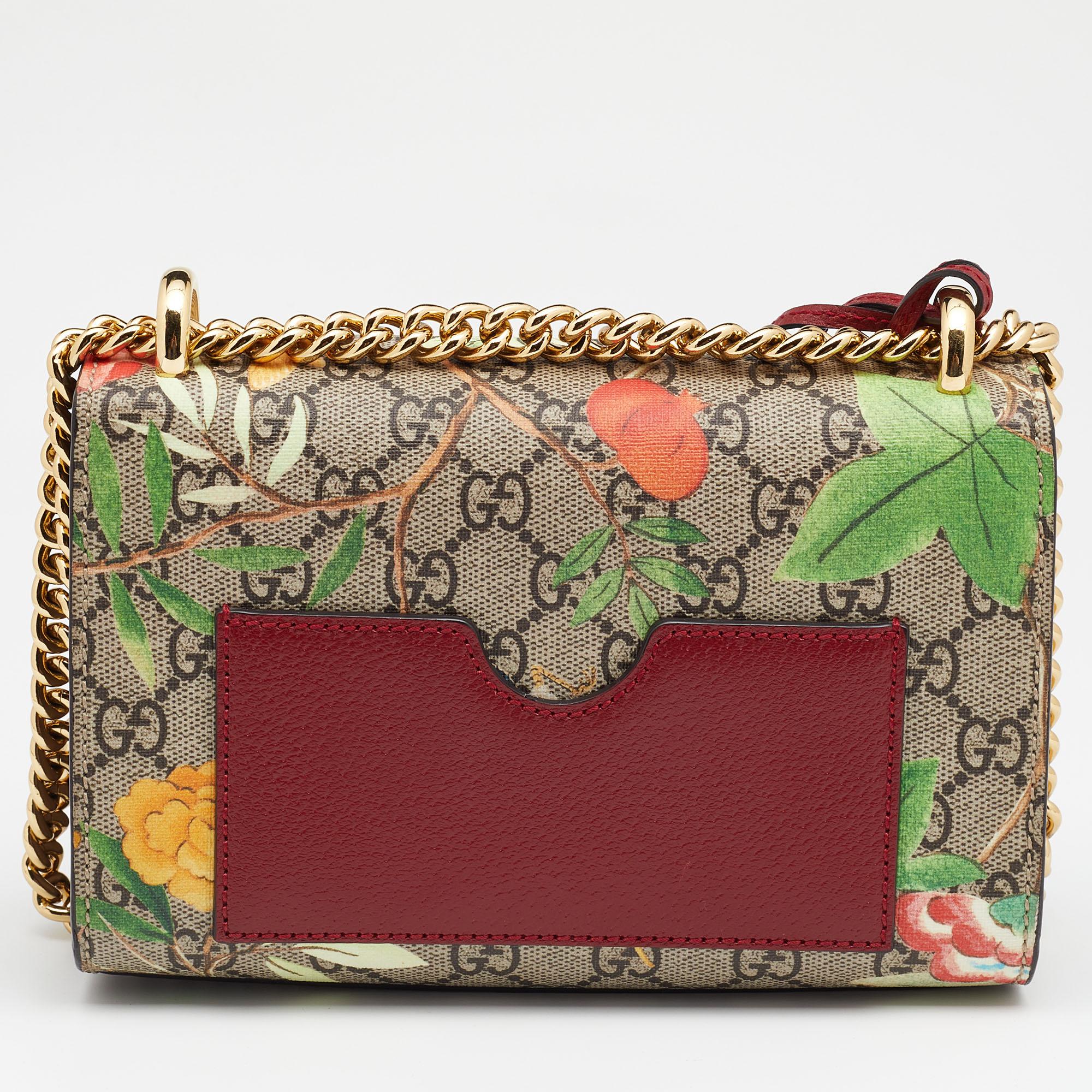 Embodying the vibrant spirit of the House, this Gucci shoulder bag is elevated with the Tian print on the GG Supreme canvas and leather exterior. It has a metal lock on the flap to secure the Alcantara-lined interior and a chain is provided for