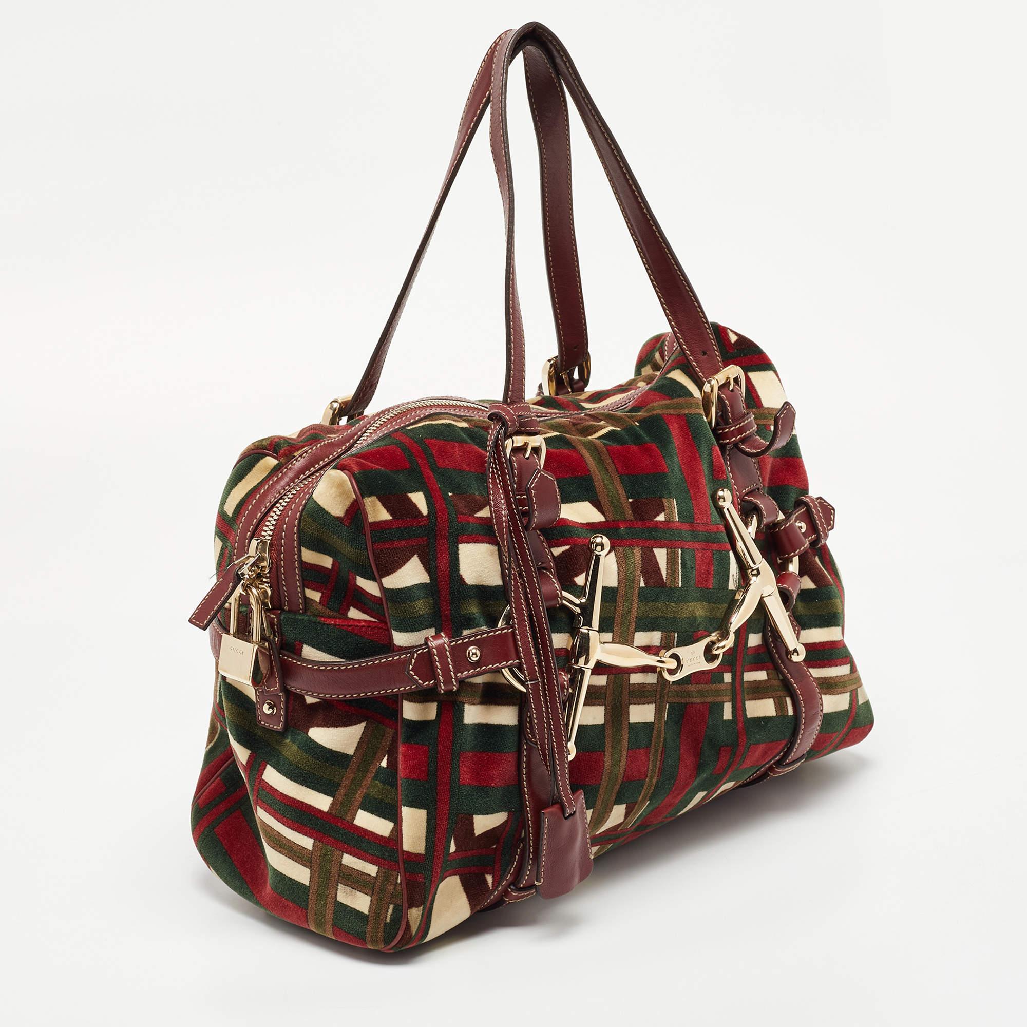 This gorgeous Gucci bag was introduced in celebration of its 85th anniversary, and it comes crafted from velvet and leather. It has Bit accents at the front and the anniversary plaque at the back. Two handles and a spacious interior make it