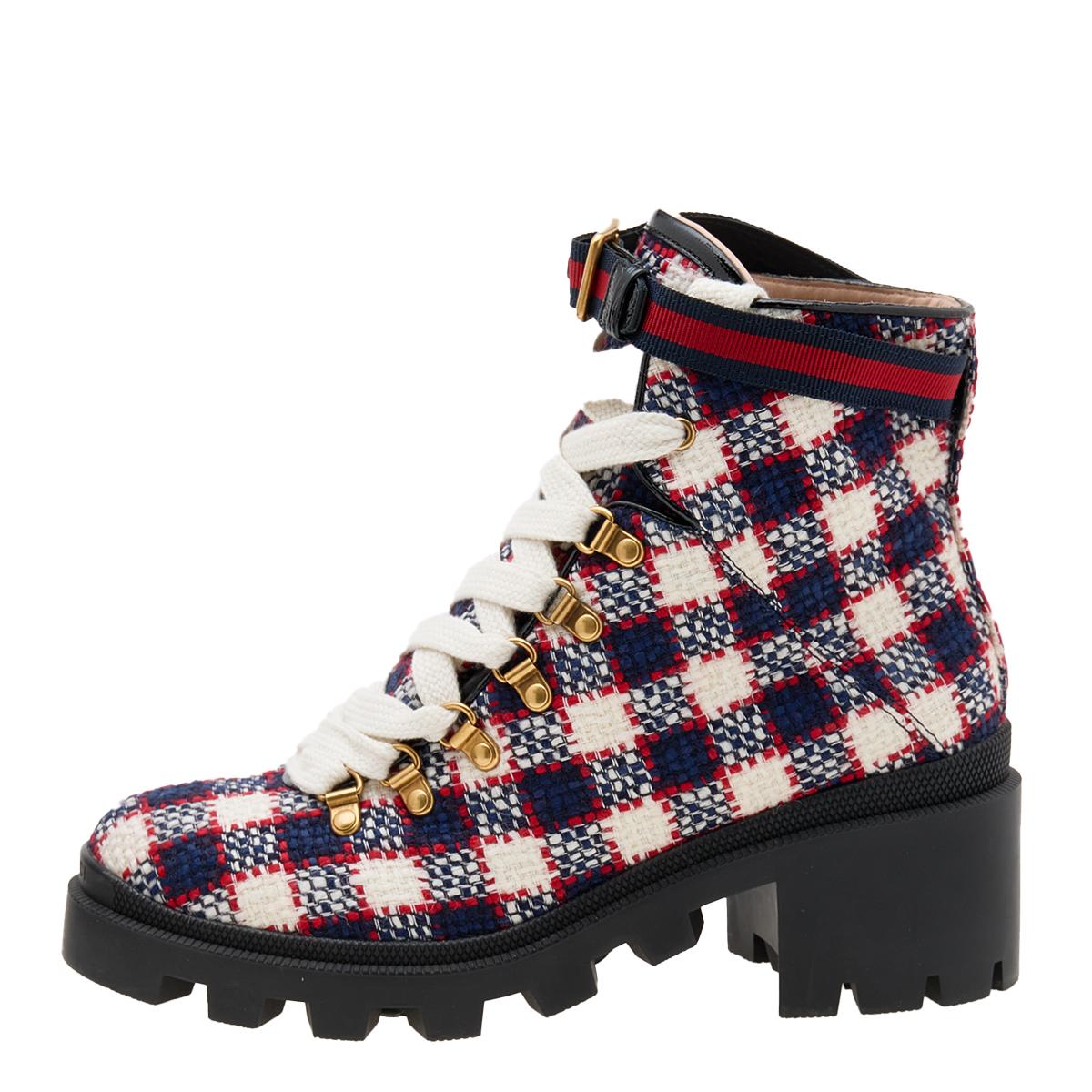 These Combat boots from the House of Gucci define style and sophistication with their trendy and sturdy structure. Made from Vintage Check tweed, their silhouette is enhanced with rubber soles, lace-ups, and 6 cm heels. They are fitted with