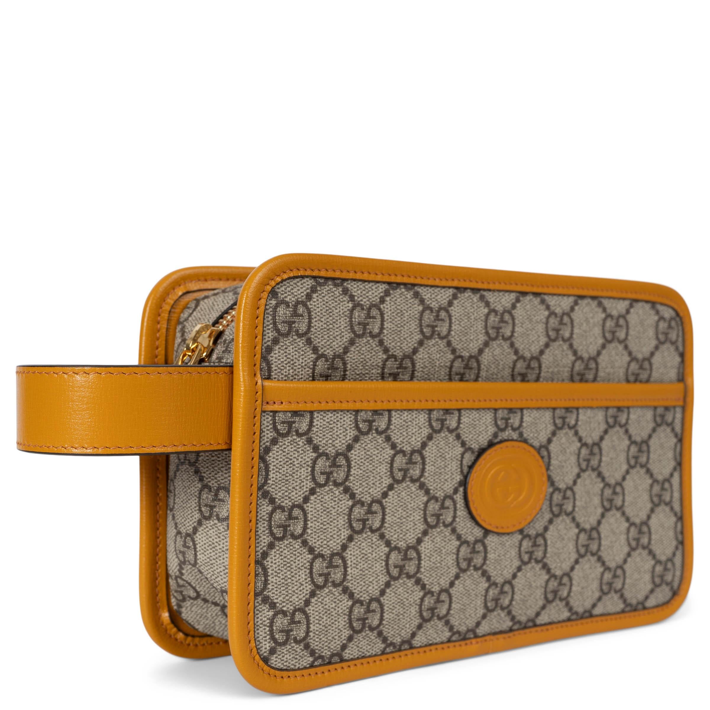 This 100% authentic Gucci travel pouch is crafted from beige and ebony GG Supreme canvas, accented with sunflower yellow leather trims for a striking look. It features a GG embossed logo leather patch, an open front pocket for easy access, and a