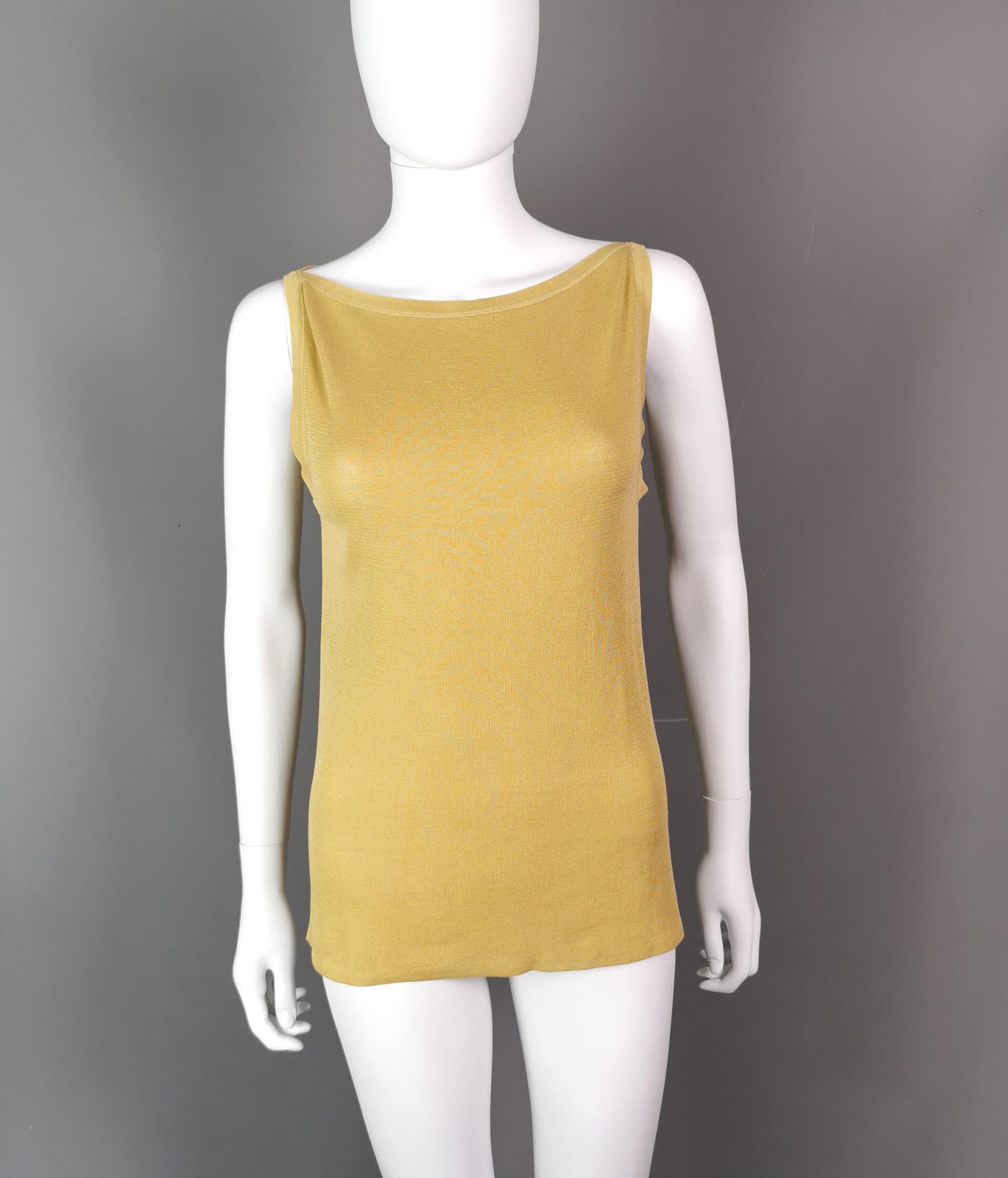 Such a versatile and stylish ladies vintage Gucci tank or vest top.

Made on Italy from 57% silk and 43% cotton it is nice and soft and lightweight.

Could be dressed up or down and it has a split style neckline, sleeveless, mid length.

The top has