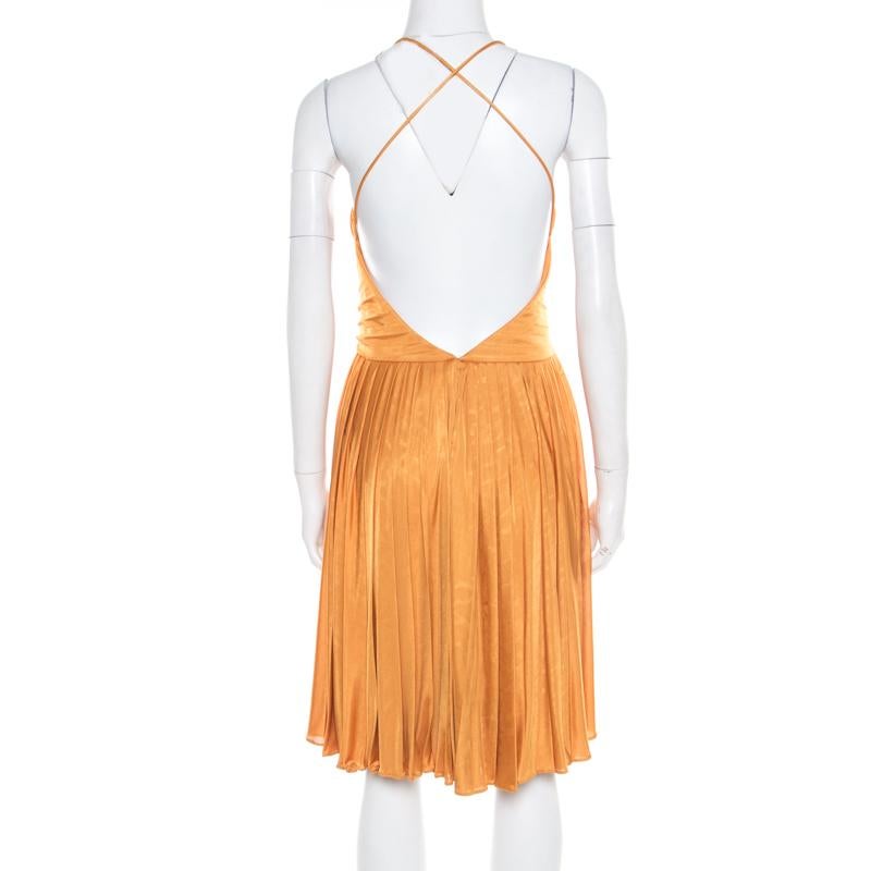 We've fallen in love with this gorgeous dress from Gucci! Vibrant in mustard yellow, this creation features a plisse silhouette and flaunts a plunging neckline and a deep cut-out back that looks amazing. Pair it with platform sandals and an