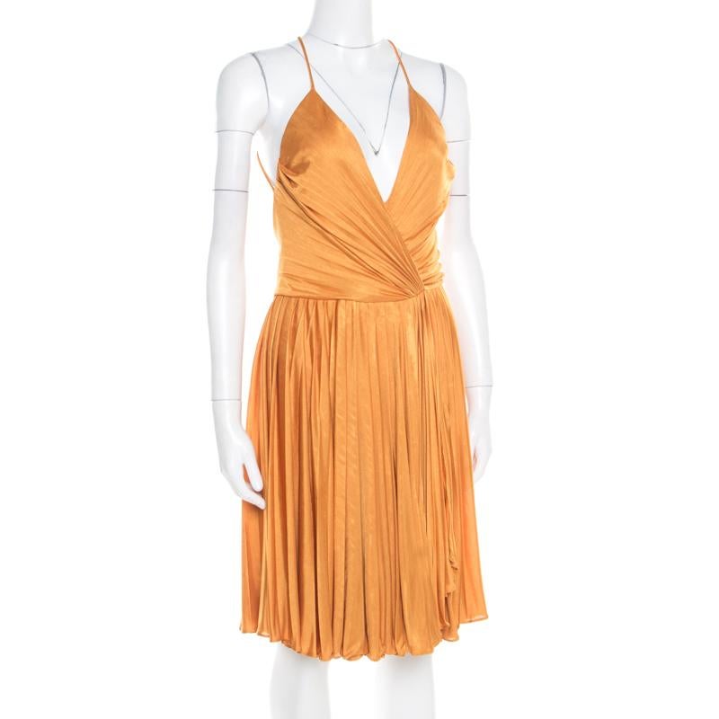 We've fallen in love with this gorgeous dress from Gucci! Vibrant in mustard yellow, this creation features a plisse silhouette and flaunts a plunging neckline and a deep cut-out back that looks amazing. Pair it with platform sandals and an