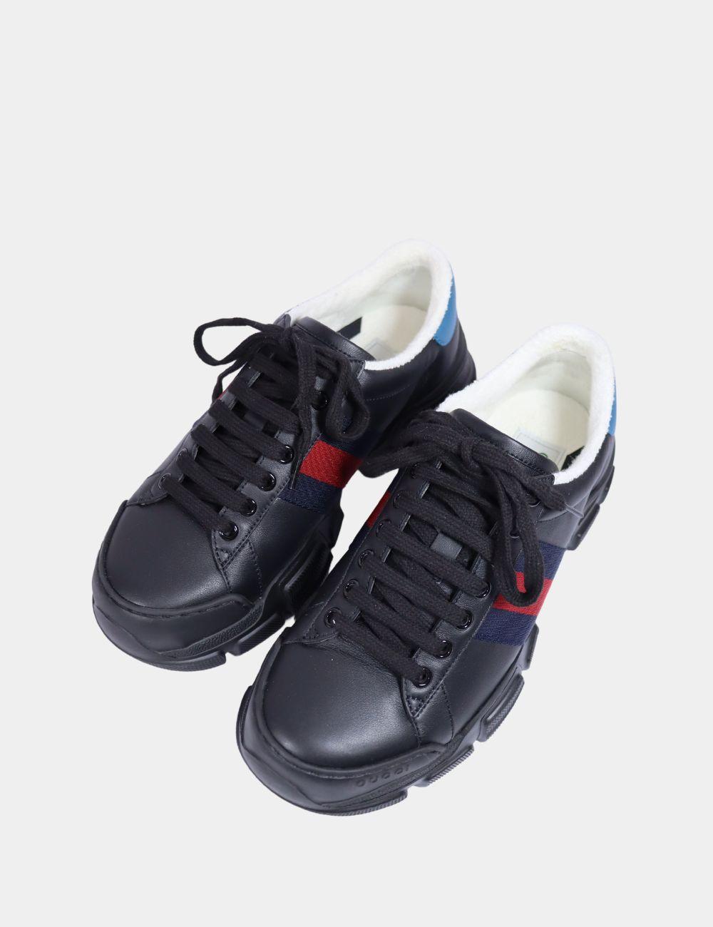 Sport meets luxury with these Gucci Black Leather Sneakers, featuring the iconic red and navy web stripe and a chunky sculpted sole. Made in Italy from premium leather, these low-top sneakers combine streetwear influence with high-end craftsmanship.