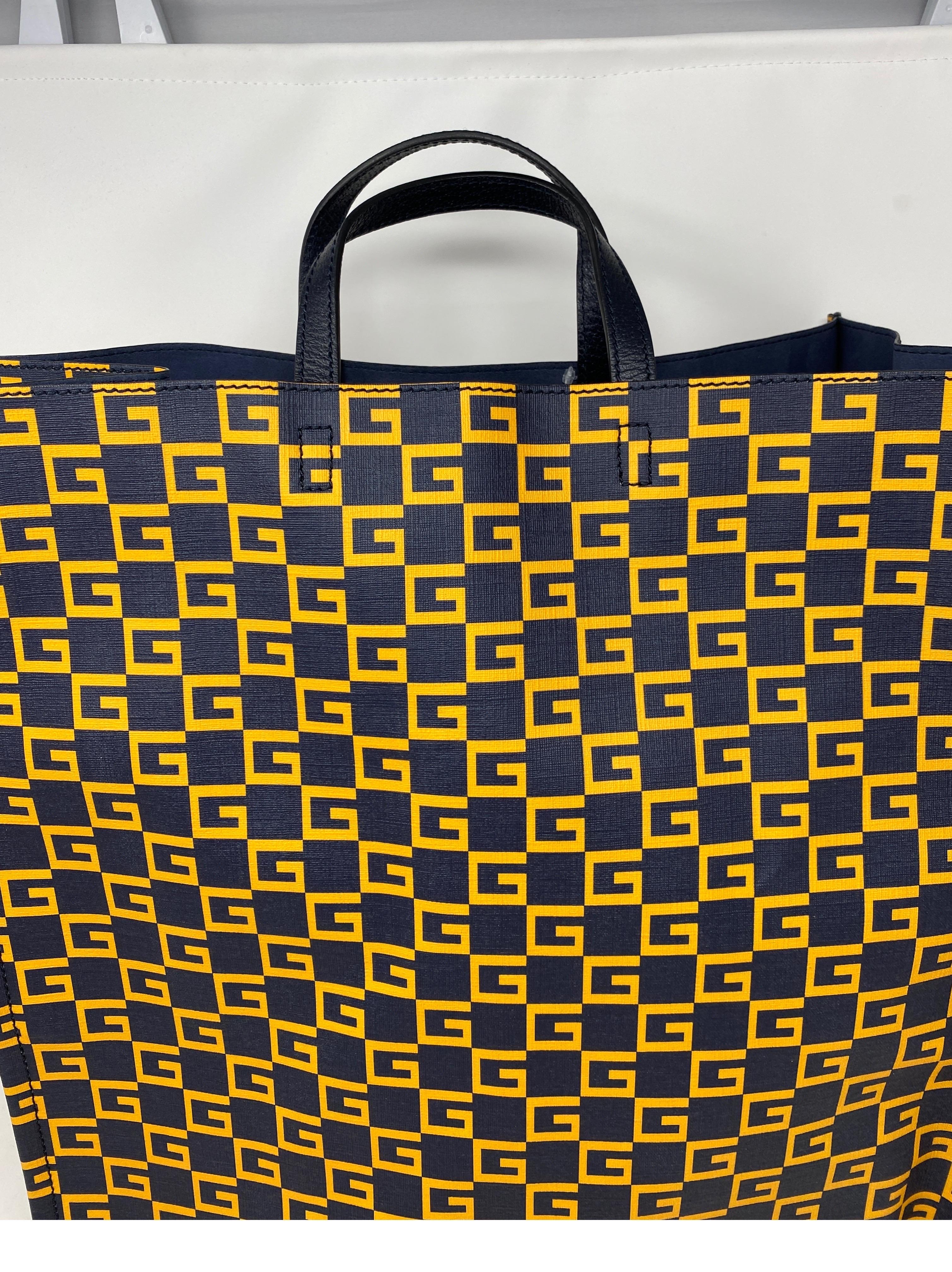 Gucci Large Navy and Gold Large Tote Bag. G all over yellow gold tote. Dark navy/ black color with navy interior. Excellent like new condition. Guaranteed authentic. 