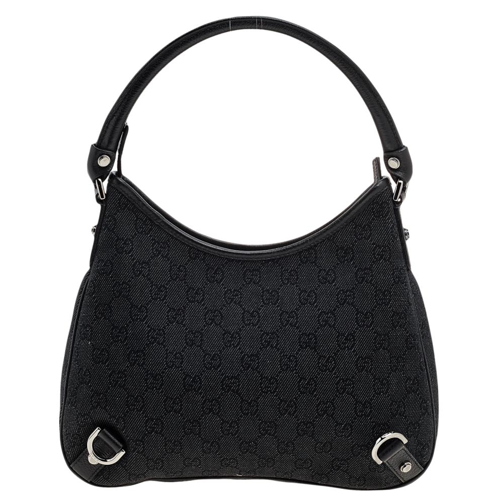 This classic Gucci Abbey hobo will give any outfit an elegant finish. It is crafted from monogram canvas with leather trim that is accented with gunmetal-toned D-rings and studs. The large fabric-lined interior features a zip pocket.