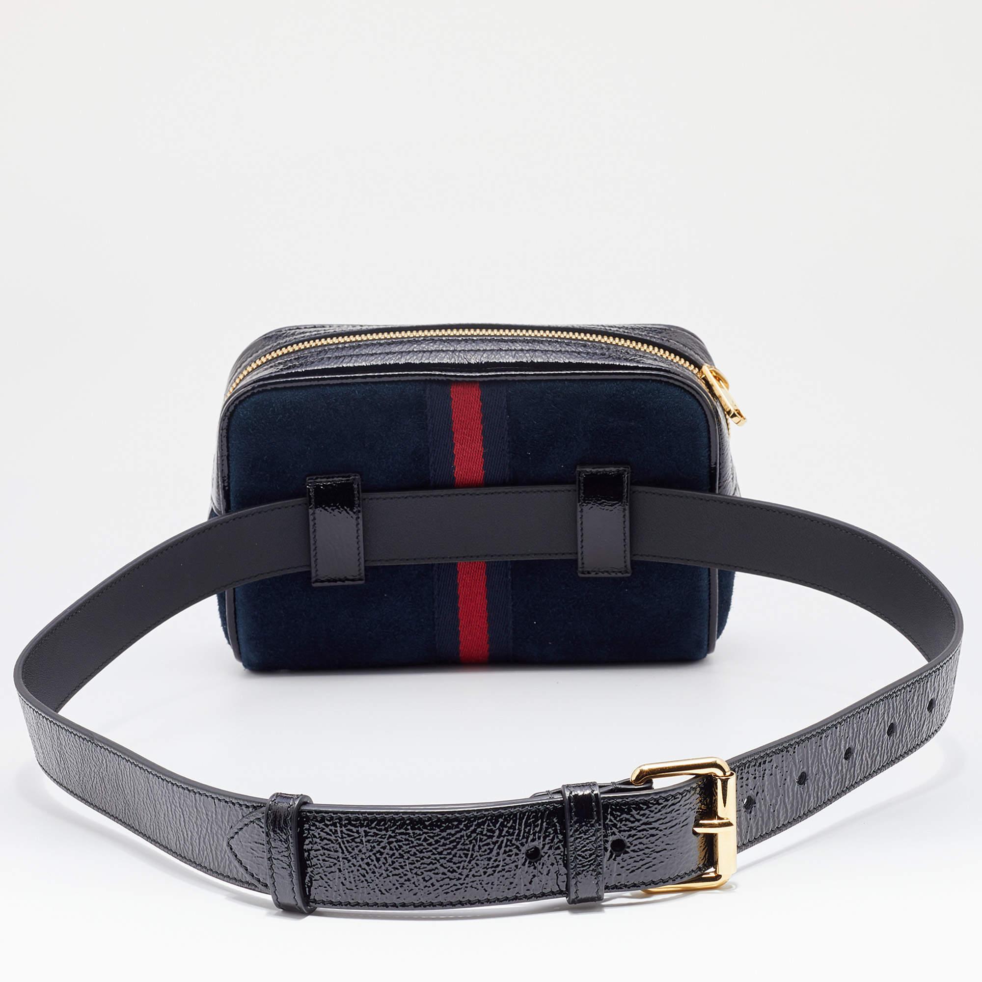 Transform your outfit with this Gucci Ophidia belt bag. It is made of suede and detailed with patent leather trims, the signature GG logo on the front, and Web trim detailing. It is complete with an adjustable belt strap.

Includes: Info Booklet,