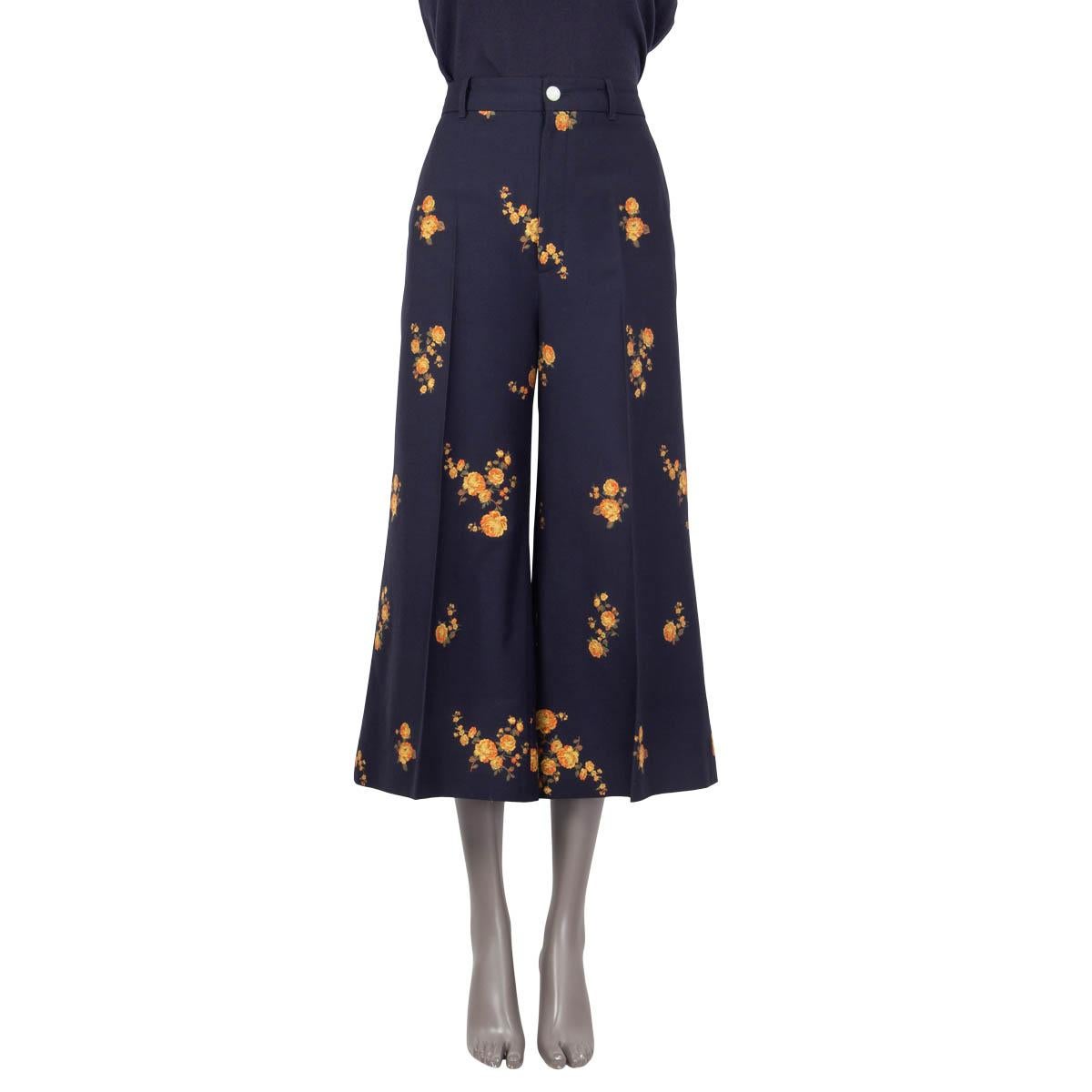 100% authentic Gucci high-waist culotte pants in dark navy blue cotton (60%) and wool (40%). Cruise 2019 collection. Feature belt loops, side and back pockets and camellia print in orange, olive green and yellow. Open with concealed zipper and a