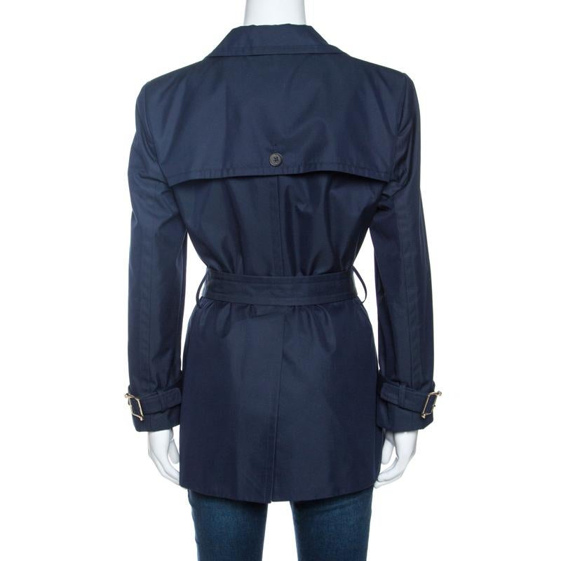 To warm all your chilly days with high-fashion, the house of Gucci brings you this fabulous coat. It features a double-breasted design, an understated navy blue hue all over, notched lapels and a waist belt. The coat has a luxurious feel and we are