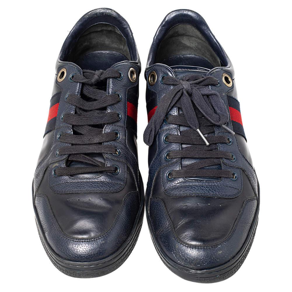 Bring home the luxurious high-fashion touch with these sneakers from Gucci. Crafted from leather, these navy blue sneakers come flaunting suave details like the patent leather trims, the web stripes, the lace-up, and the brand label on the midsoles.