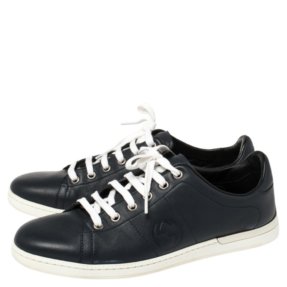 Let your latest shoe addition be this pair of navy blue low-top sneakers from Gucci. They've been crafted from leather and styled with contrasting white lace-ups, GG logo on the quarters and on the counters. They are complete with comfortable