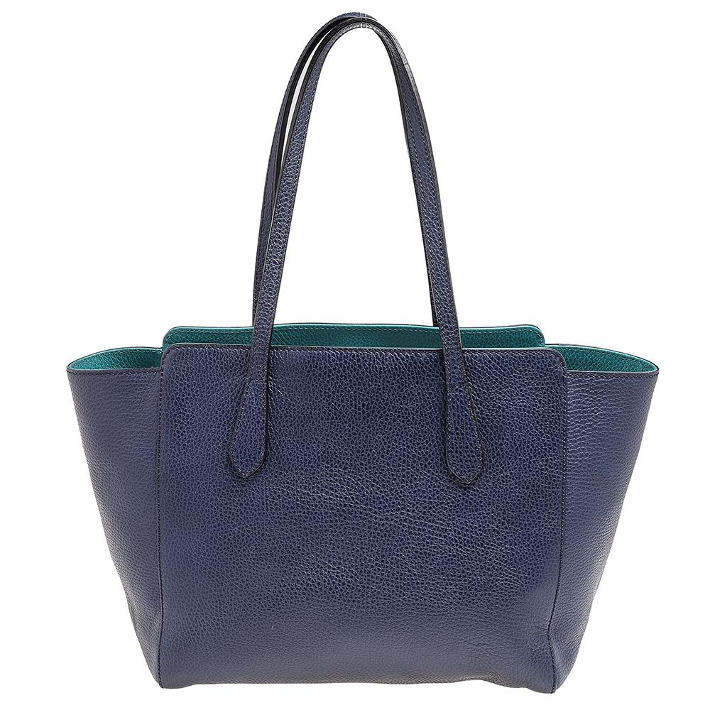 From the House of Gucci, this tote fulfills your handbag requirements quite effortlessly. They are crafted using navy-blue leather on the exterior and flaunt gold-toned hardware, dual handles, and a structured shape. Carry your everyday belongings